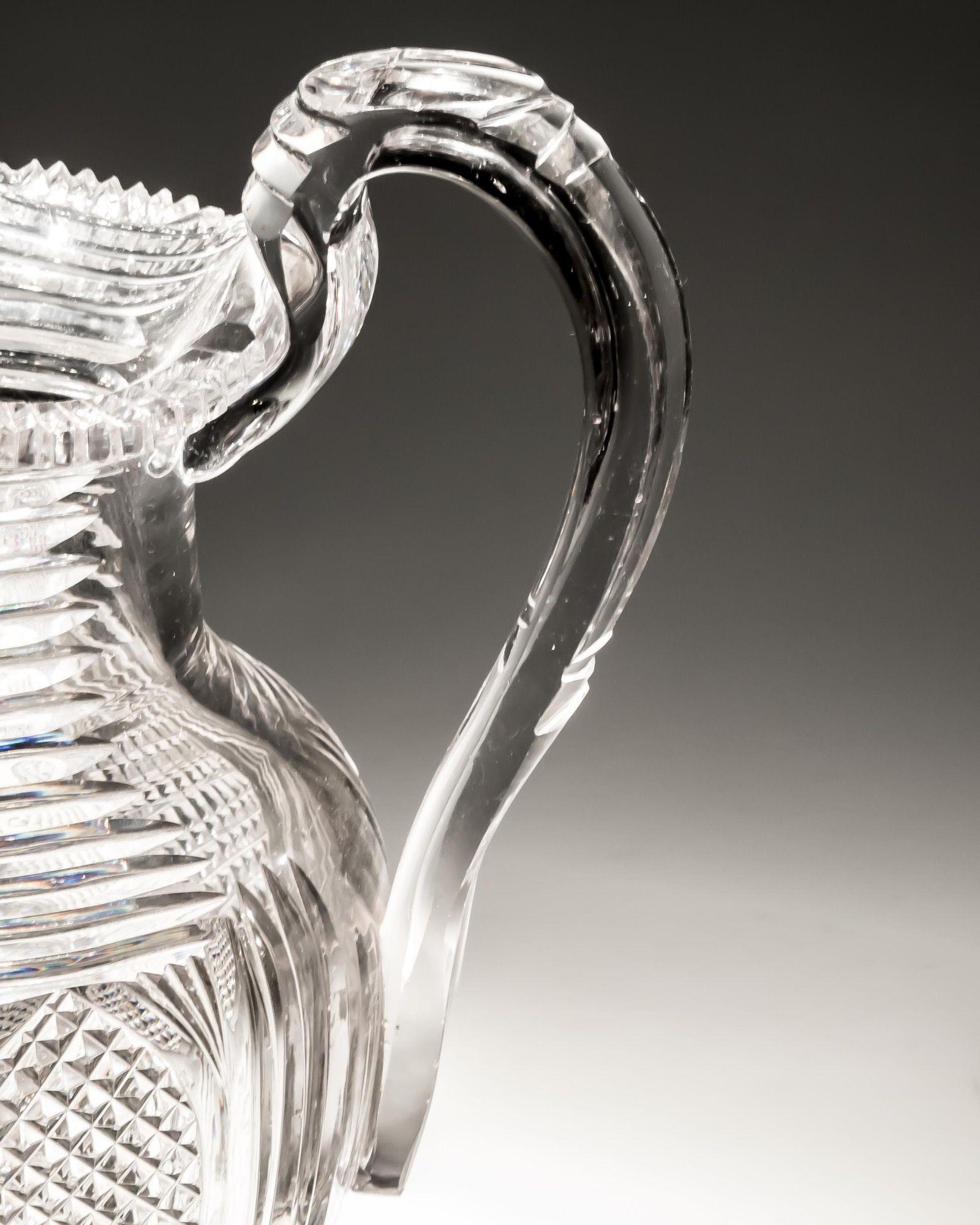 A fine Regency water jug cut with unusual arched diamond panels and step cut neck.

England, circa 1820.

Measures: Height: 22 cm (8 3/4