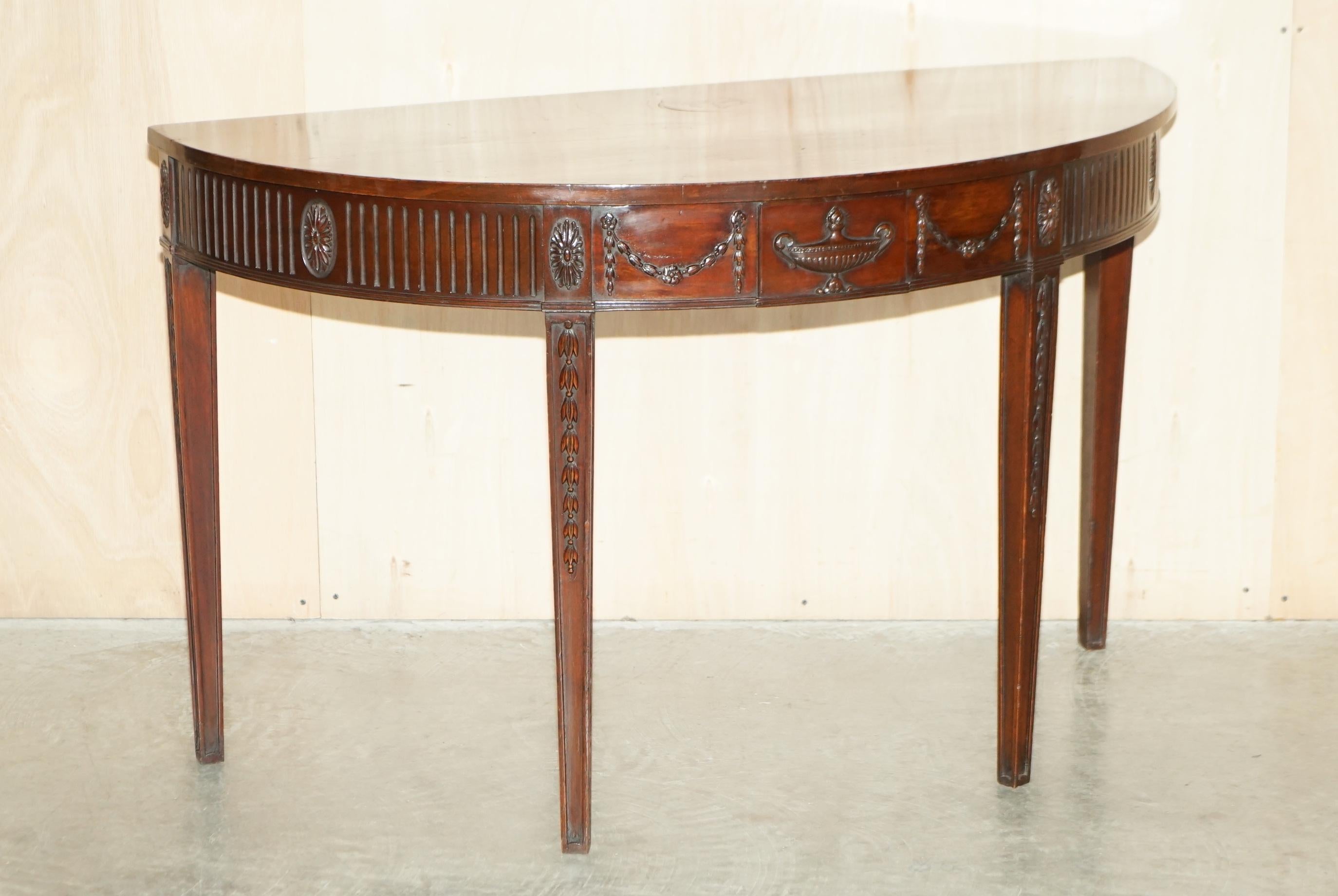 Royal House Antiques

Royal House Antiques is delighted to offer for sale this rare and important Adams style 18th century hand carved and fully restored demi lune console table with solid slab top burl mahogany top

Please note the delivery fee