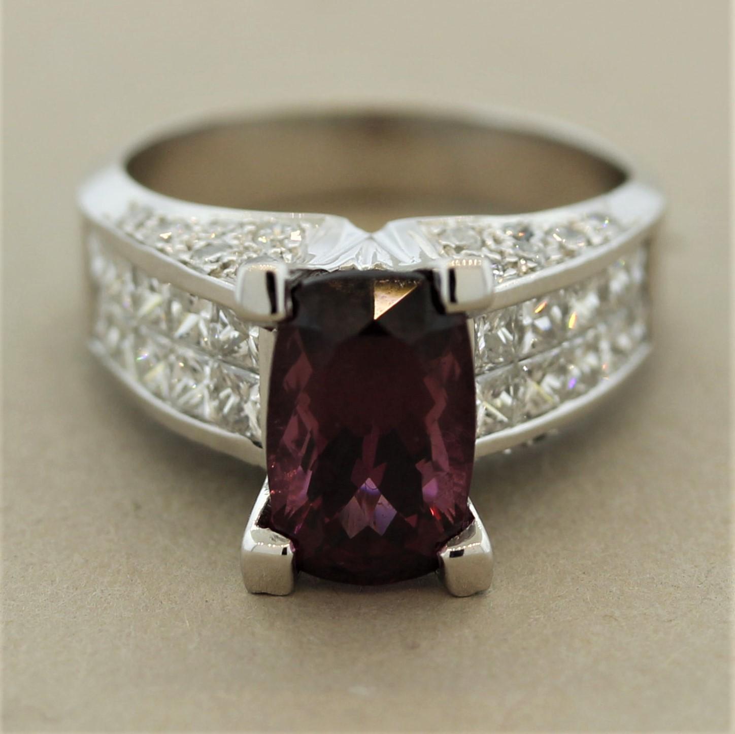 A gemmy 3.35 carat rhodolite garnet with a bright and vivid red-purple color takes center stage. It is accented by 1.48 carats of round brilliant-cut and princess-cut diamonds set atop the ring and on its sides. Made in 18k white gold.

Ring Size
