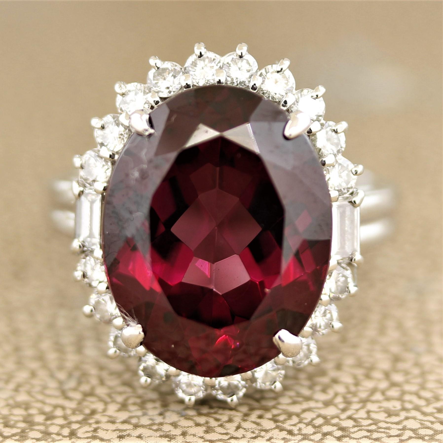 Simply stunning. The ring features a superb gem of a gem rhodolite garnet weighing 13.14 carats. It has a bright and brilliant purple-red color that rivals the finest tourmalines and rubies. It is accented by 0.97 carats of round brilliant and