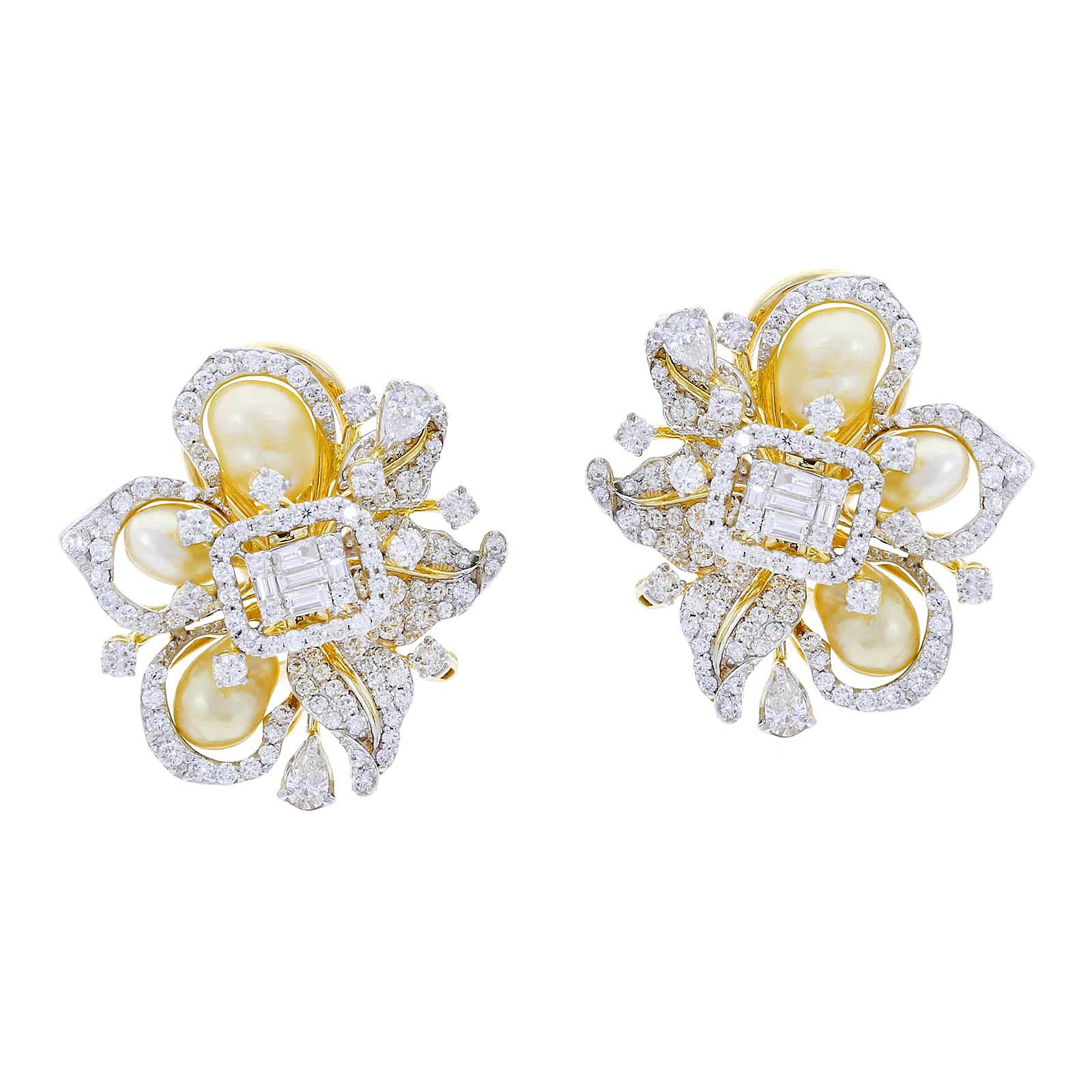 A stylish pair of ribbon-style earrings set with combinations of two most elegant jewels: pearls and diamonds. The pearls weigh appx. 9.7 cts. and the diamonds (mix of rounds, tapered, and pears) are 3.34 cts. Estimated Clarity: VS, Color: H. Set in