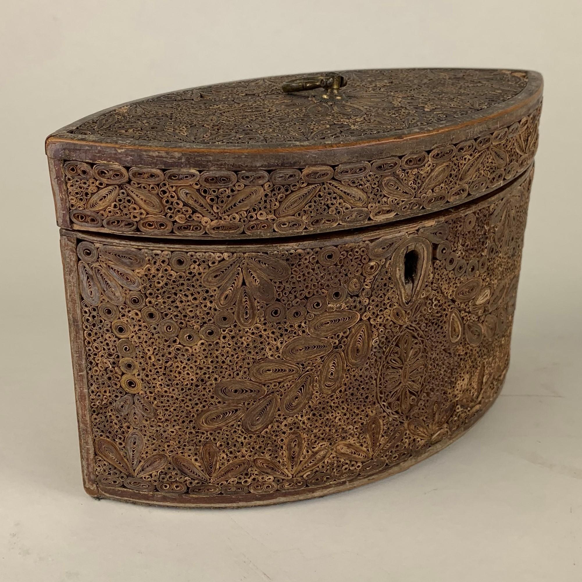 A fine quality rolled/scrolled paperwork single compartmemt tea caddy in good originl condition with minor losses. Decorated all-over with applied scrolls of gilt edged and coloured paper, with original green baize to base and original lock. the