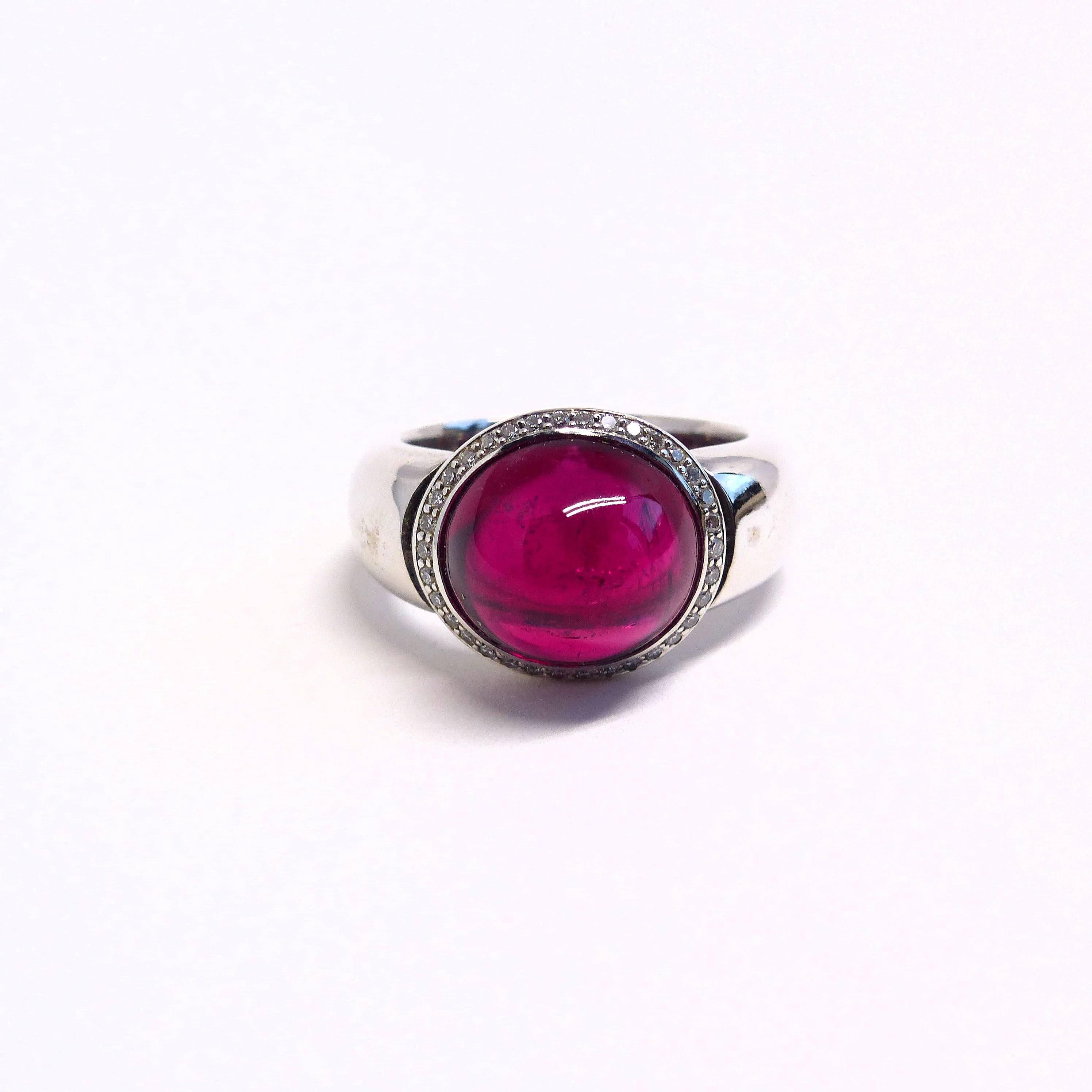 Thomas Leyser is renowned for his contemporary jewellery designs utilizing fine gemstones. 

This 18k white gold ring (18.25g) with 1x fine Rubelite Cabouchon (oval, 13x12mm, 10.59ct) + 24x Diamonds (brillant-cut, 1mm, G/VS). 

Ringsize 7 3/4 (56.5)