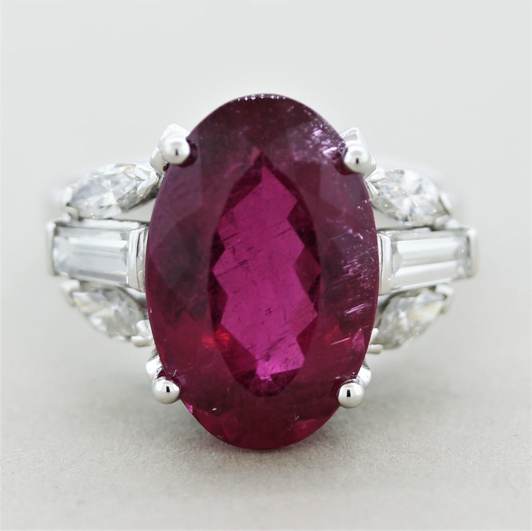 An intense raspberry red tourmaline weighing 9.17 carats takes center stage! Known in the trade as “rubellite” for its red ruby like color, it is a top-quality tourmaline. It is accented by 6 large diamonds set on its sides, 4 marquise-shape and 2