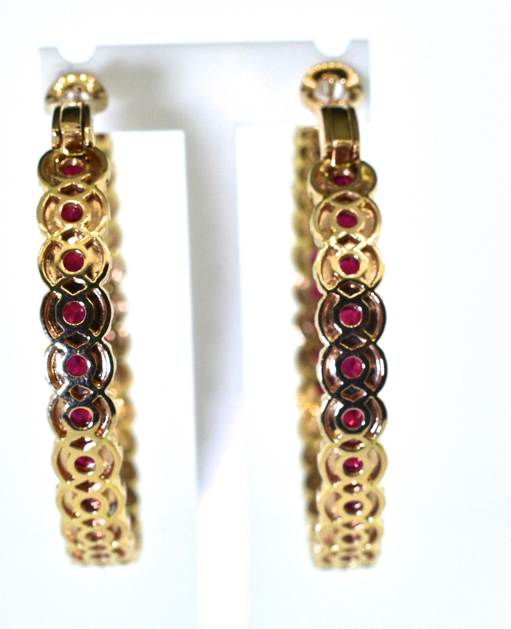 Diamond and ruby hoop earrings, large in size and well made.  There are 56 fine natural rubies weighing 5.8 cts, and 400 round brilliant cut fine white diamonds weighing 7.0 cts.  These 18K rose gold hoops have an interior diameter of 1.58 inches. 