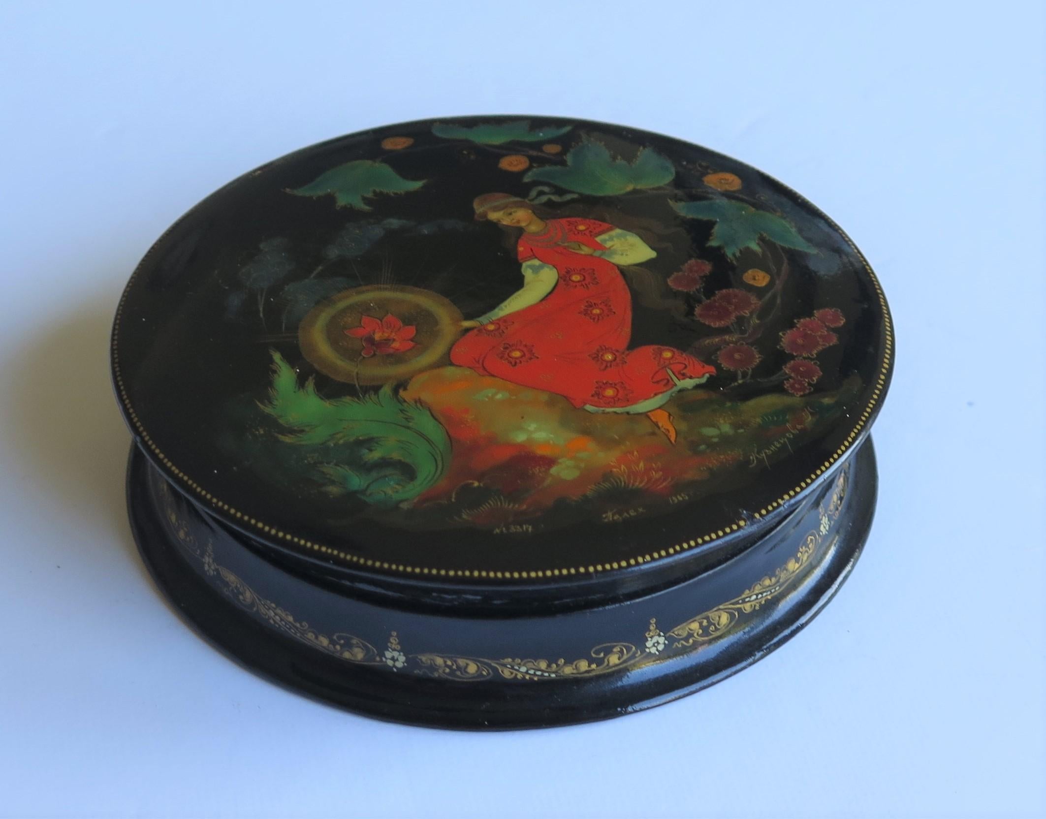 This is a very finely hand painted lidded lacquered box made in Russia, fully signed and dated 1965 which we attribute to the Palekh region workshop. 

The circular box has been beautifully made and decorated. It is very finely hand painted with a