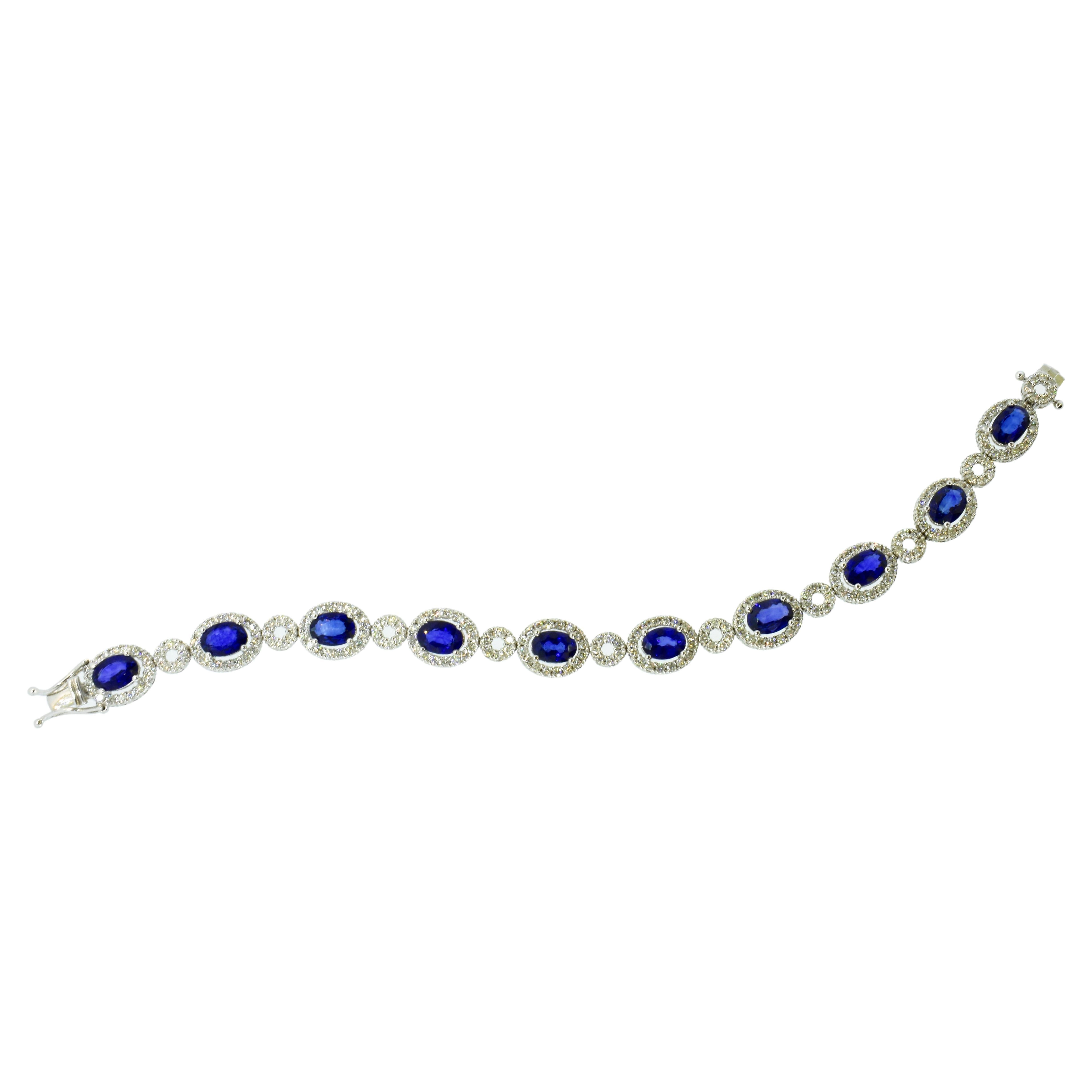 Diamond and fine natural sapphire contemporary bracelet. This well made white gold bracelet possesses 10 fine natural vivid blue oval sapphires. These stones exhibit a clear blue color with no undesirable undertones - such as green, and the clarity