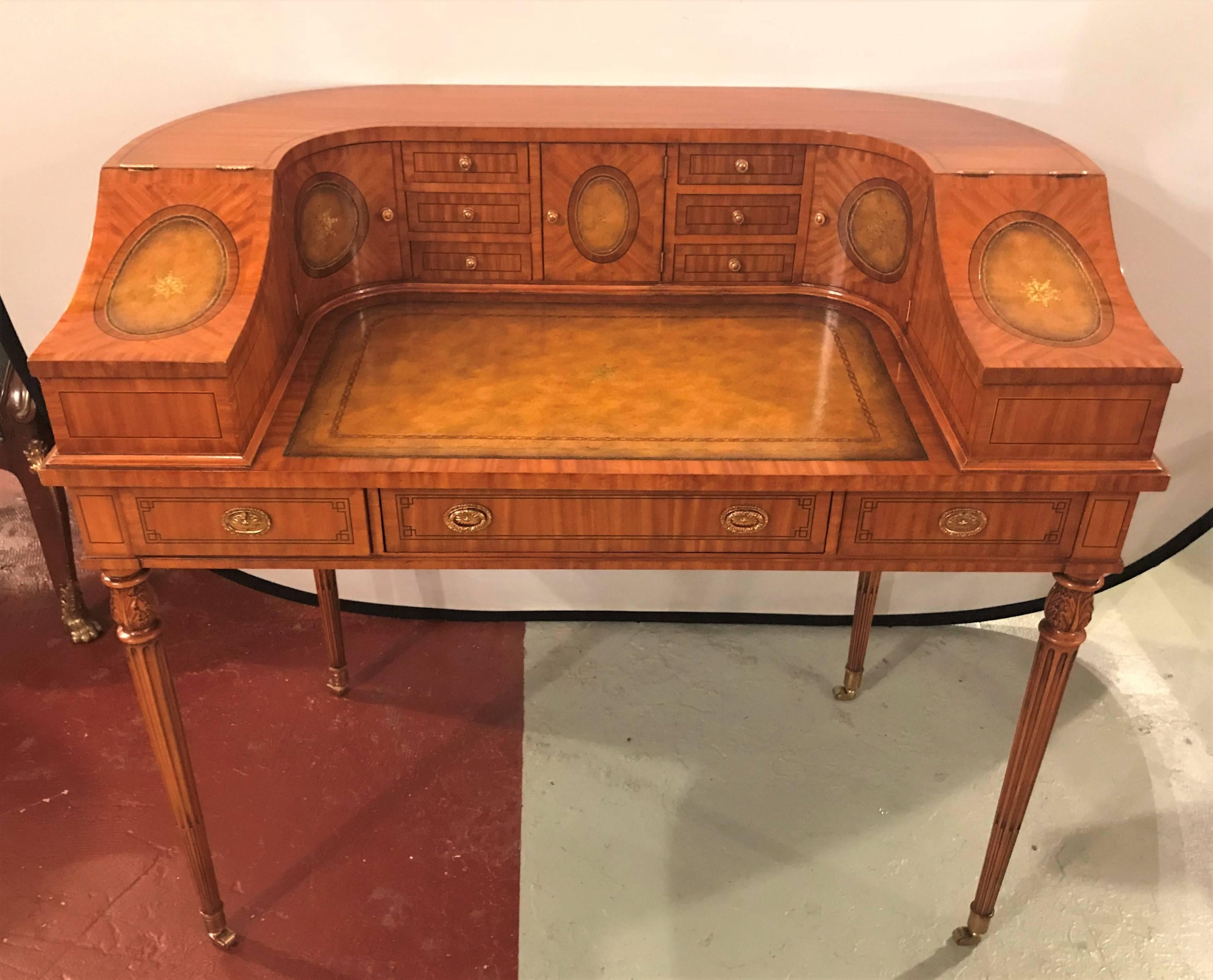 A fine satinwood Adams style Carlton house desk by Maitland-Smith. Finely crafted and well designed desk in the Kaufman style with tapering legs on bronze casters supporting an upper case of three drawers and a Carlton House compartmental set up on