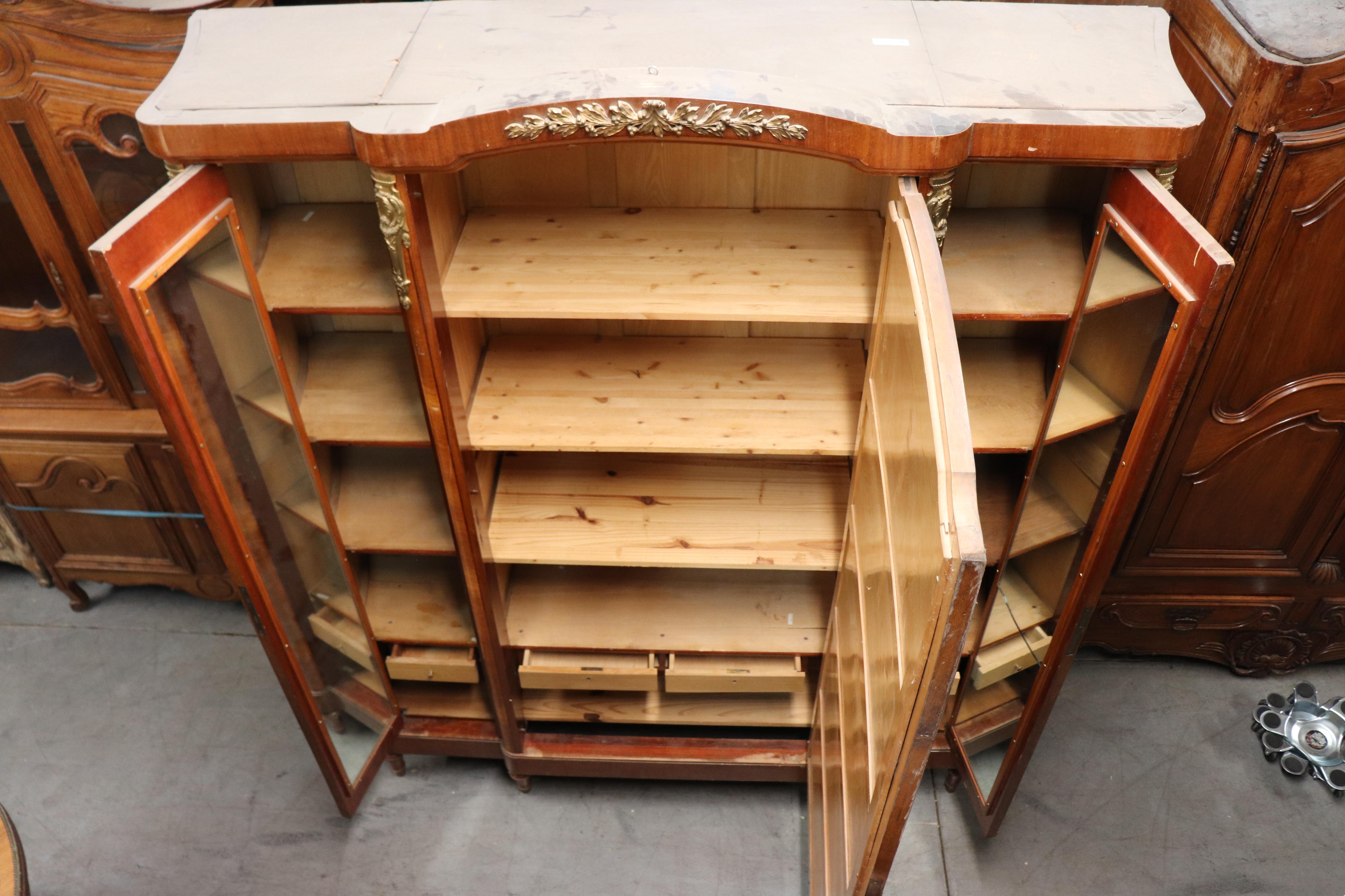 This fantastic transitional Louis XVI to Art Nouveau armoire is absolutely gorgeous. The armoire features beautiful, burled walnut in a satinwood case with mirrors on the interior and a mirrored door on the outside. The bronze is beautifully done