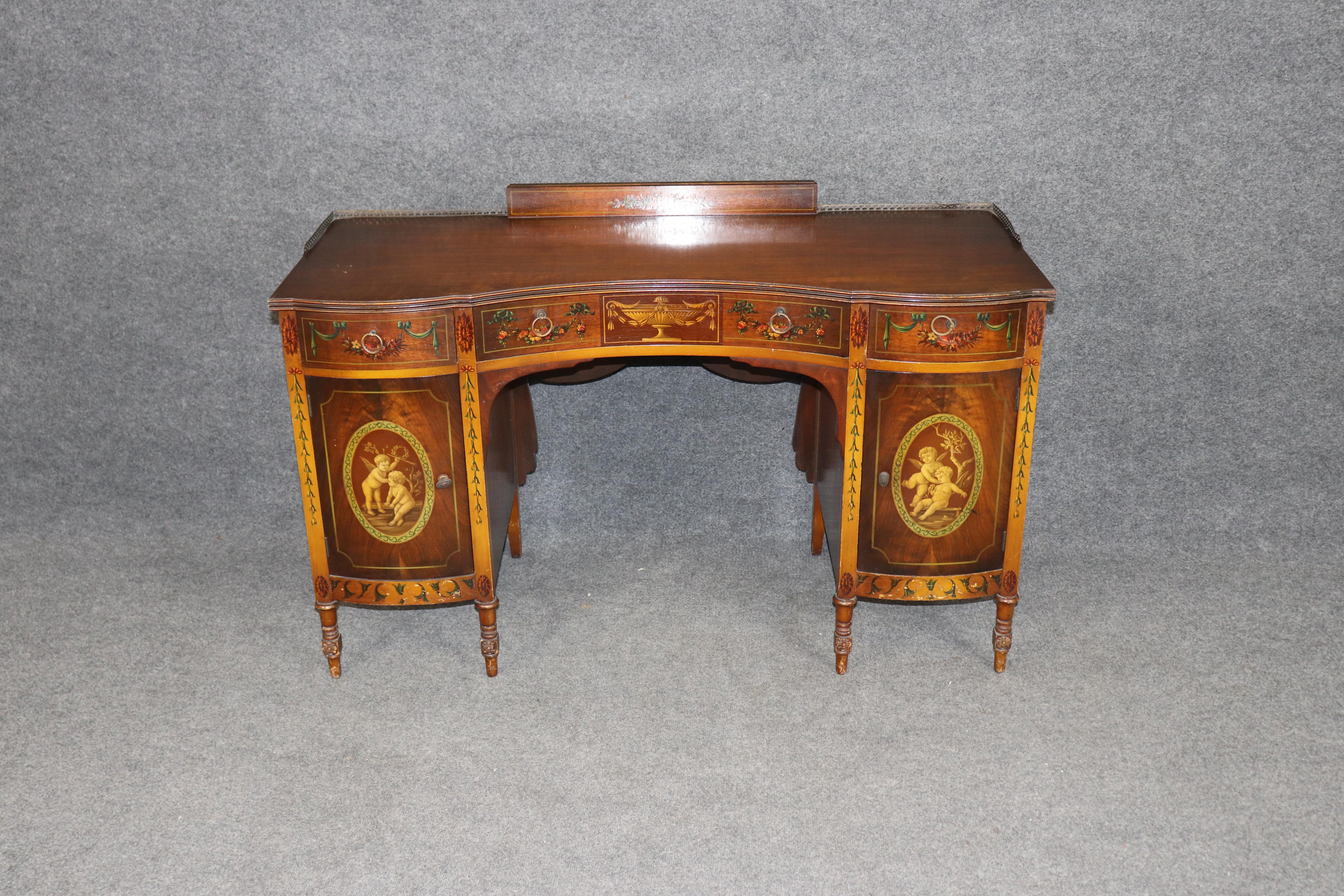 This exquisite English Adams style ladies vanity, crafted in the 1920s, showcases the timeless elegance of neoclassical design blended with early 20th-century craftsmanship. Made of fine satinwood and walnut, this vanity is richly paint decorated