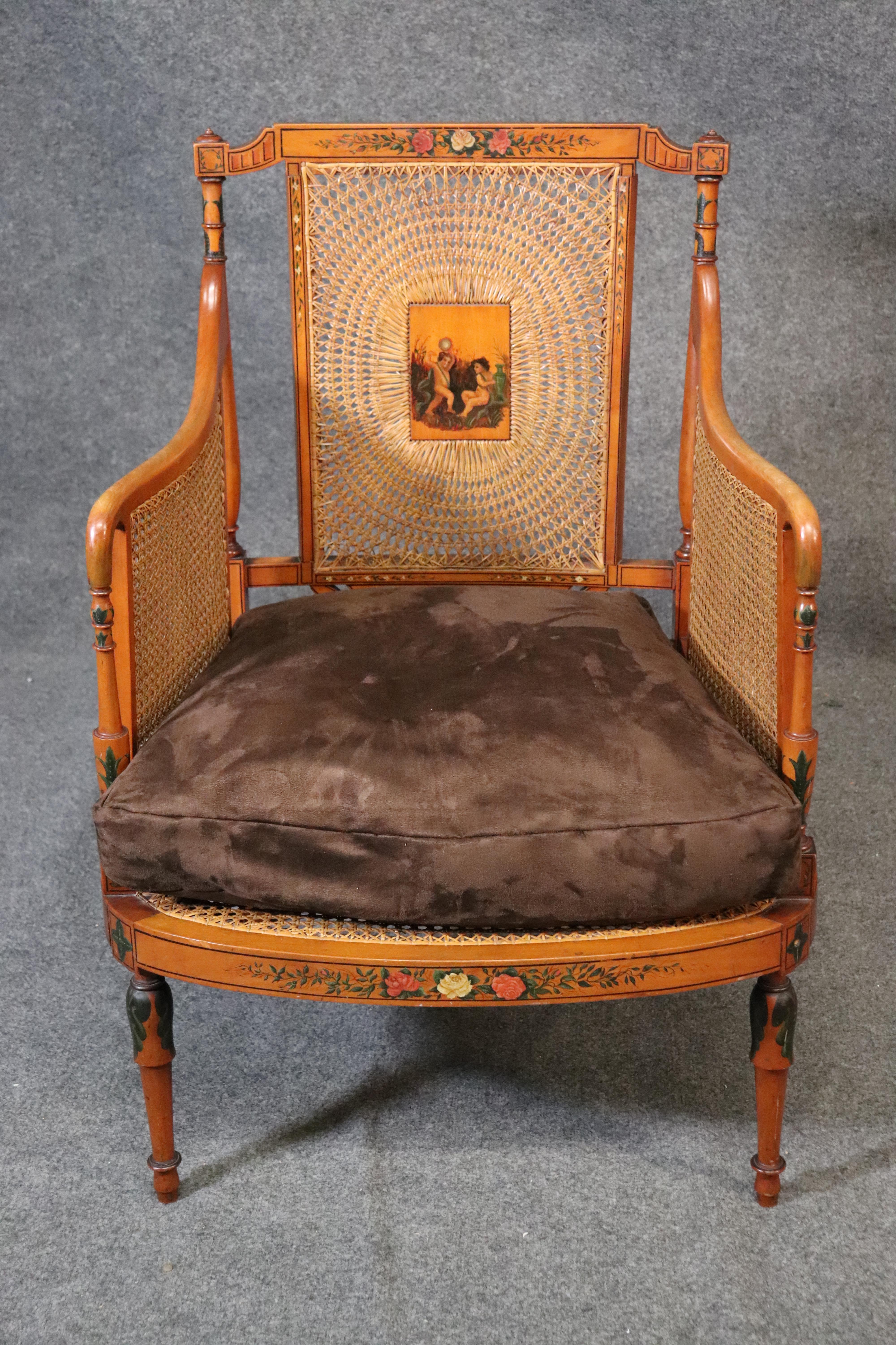 This is a gorgeous Satinwood English cane armchair or bergere chair. The chair is in good original condition with no damage to the caned surfaces that I can find. The chair has hand painted scenery and is just gorgeous. Dates to the 1850s and