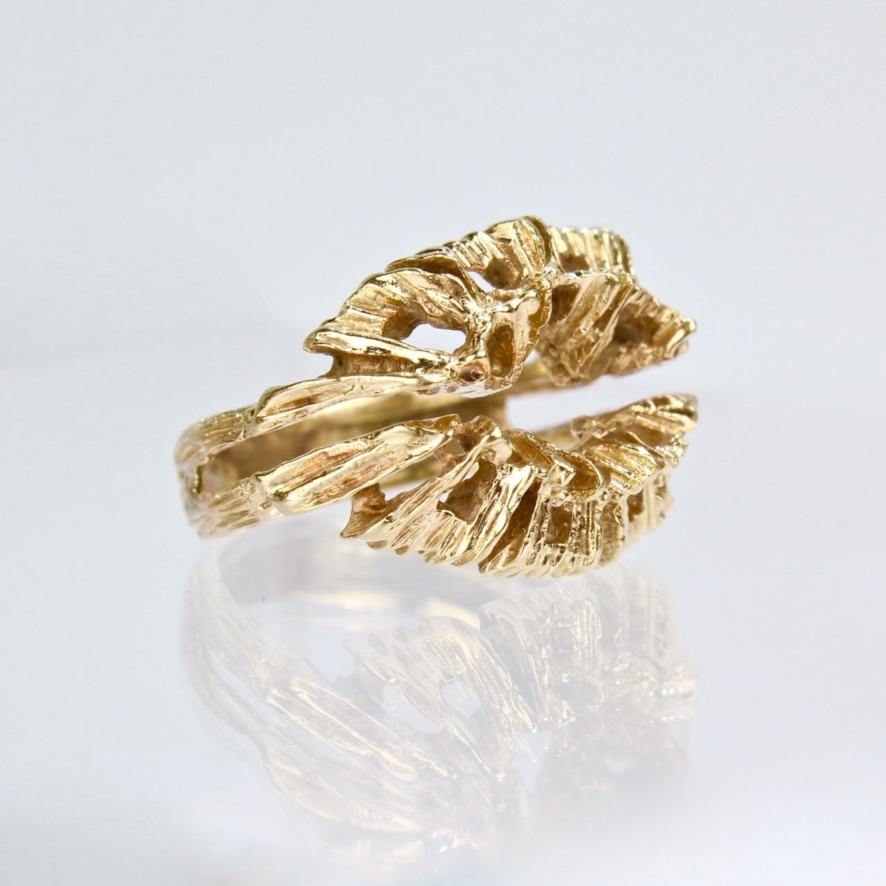 A fine, bench made Brutalist 14-karat gold ring.

With a split shank, the ring is finely cast and has burnished surface.

The crown has a matrix structure that is reminiscent of some futurist structure and an archaic honey comb relict. Both