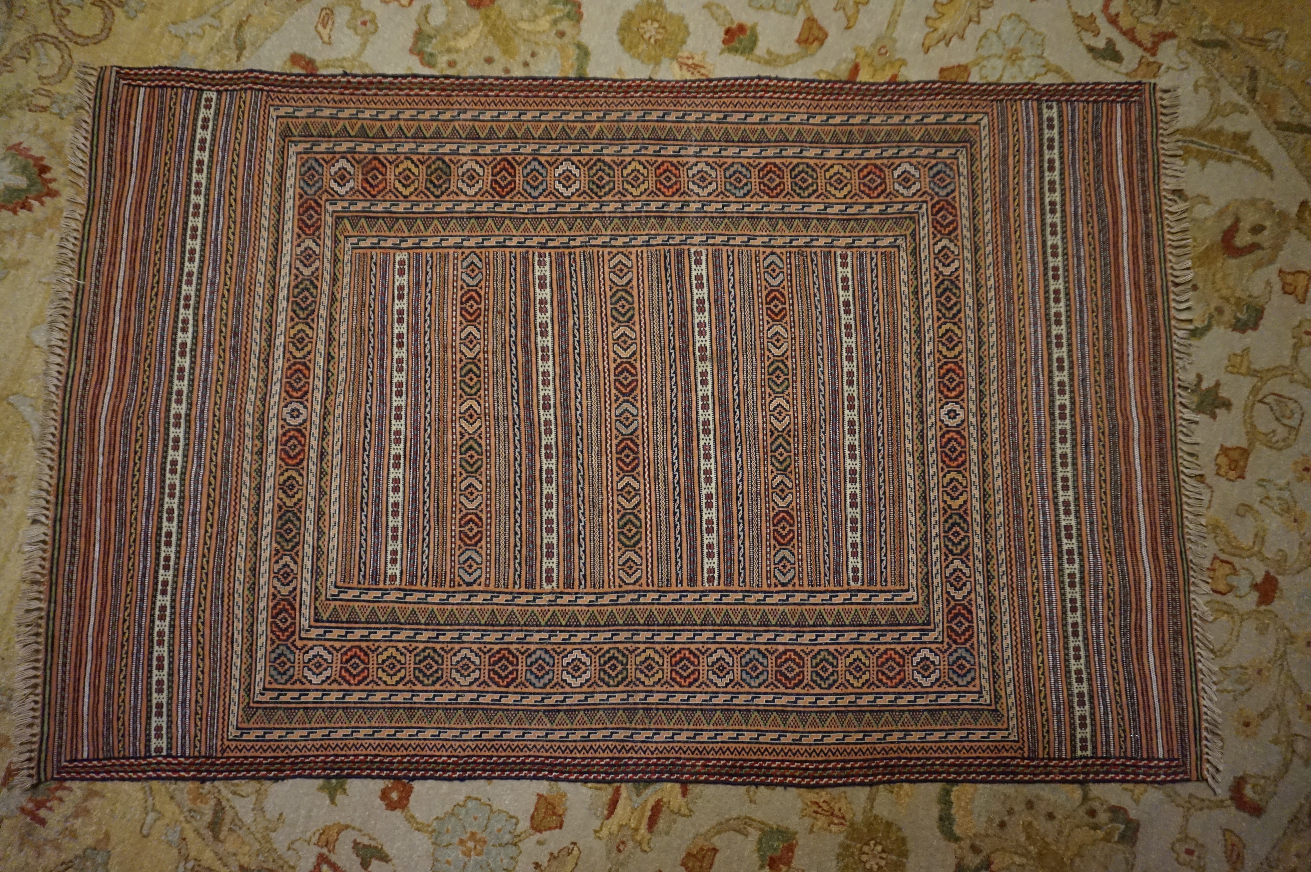 Very fine old stock striped Afghan kilim with multiple rows of geometric pattern skilfully hand knotted in soft hues. Exudes finesse.