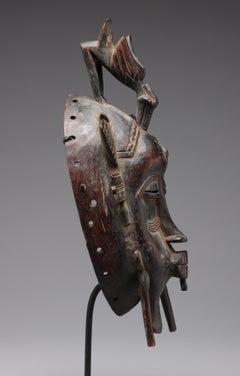 Fine Senufo Kepelie Dance Mask with Bird Figure on Top, Early 20th Century