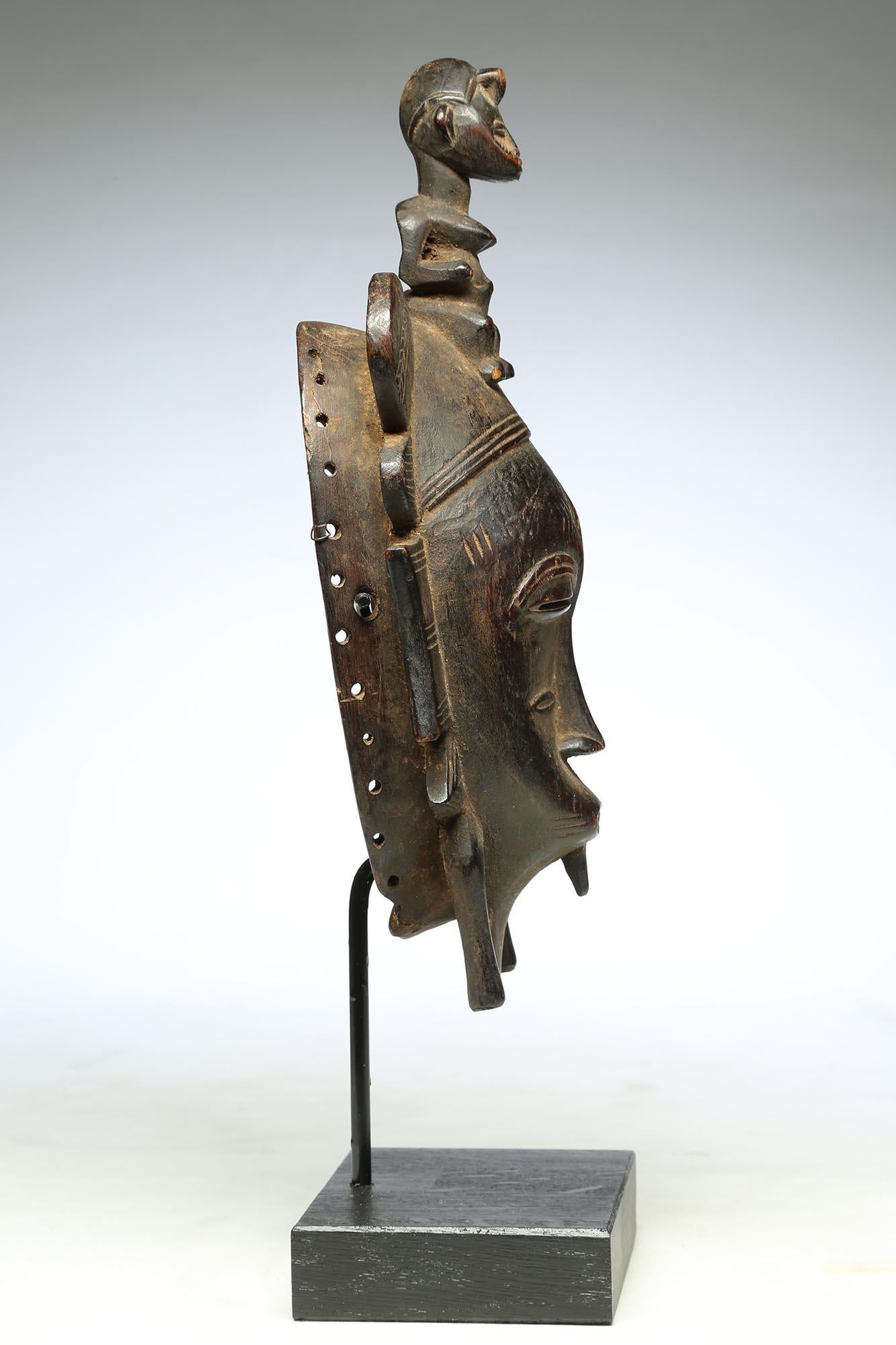 Hand-Carved Fine Senufo Kepelie Dance Mask with Female Figure on Top, Early 20th Century
