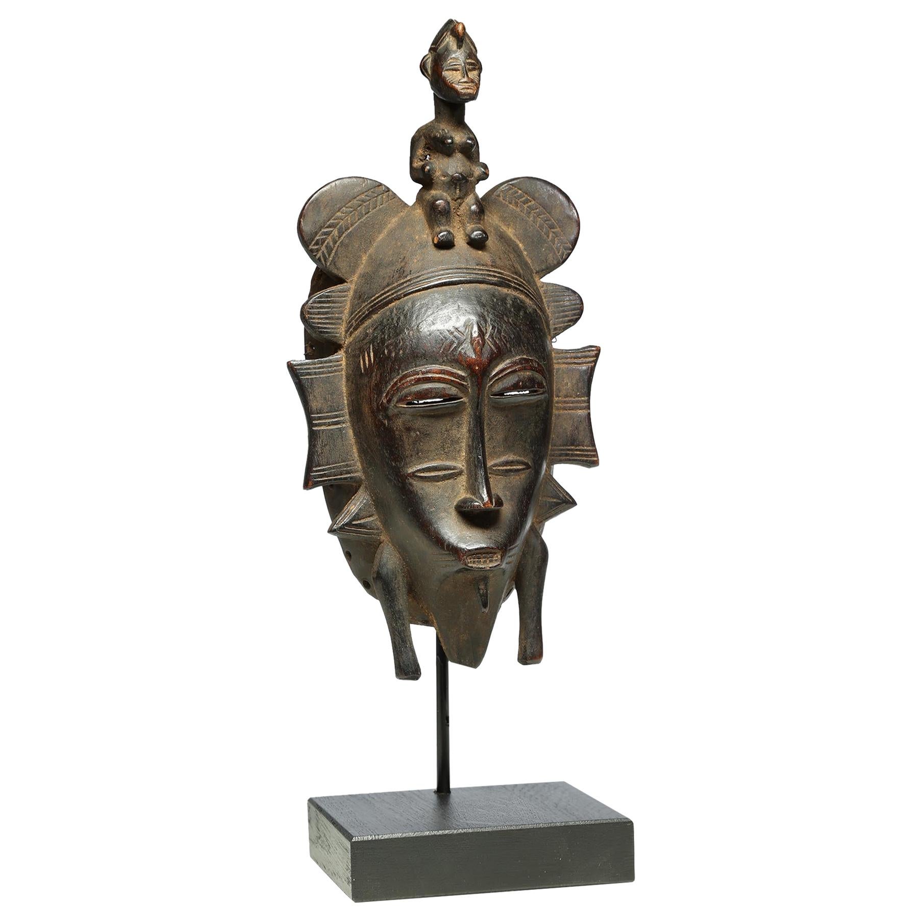 Fine Senufo Kepelie Dance Mask with Female Figure on Top, Early 20th Century