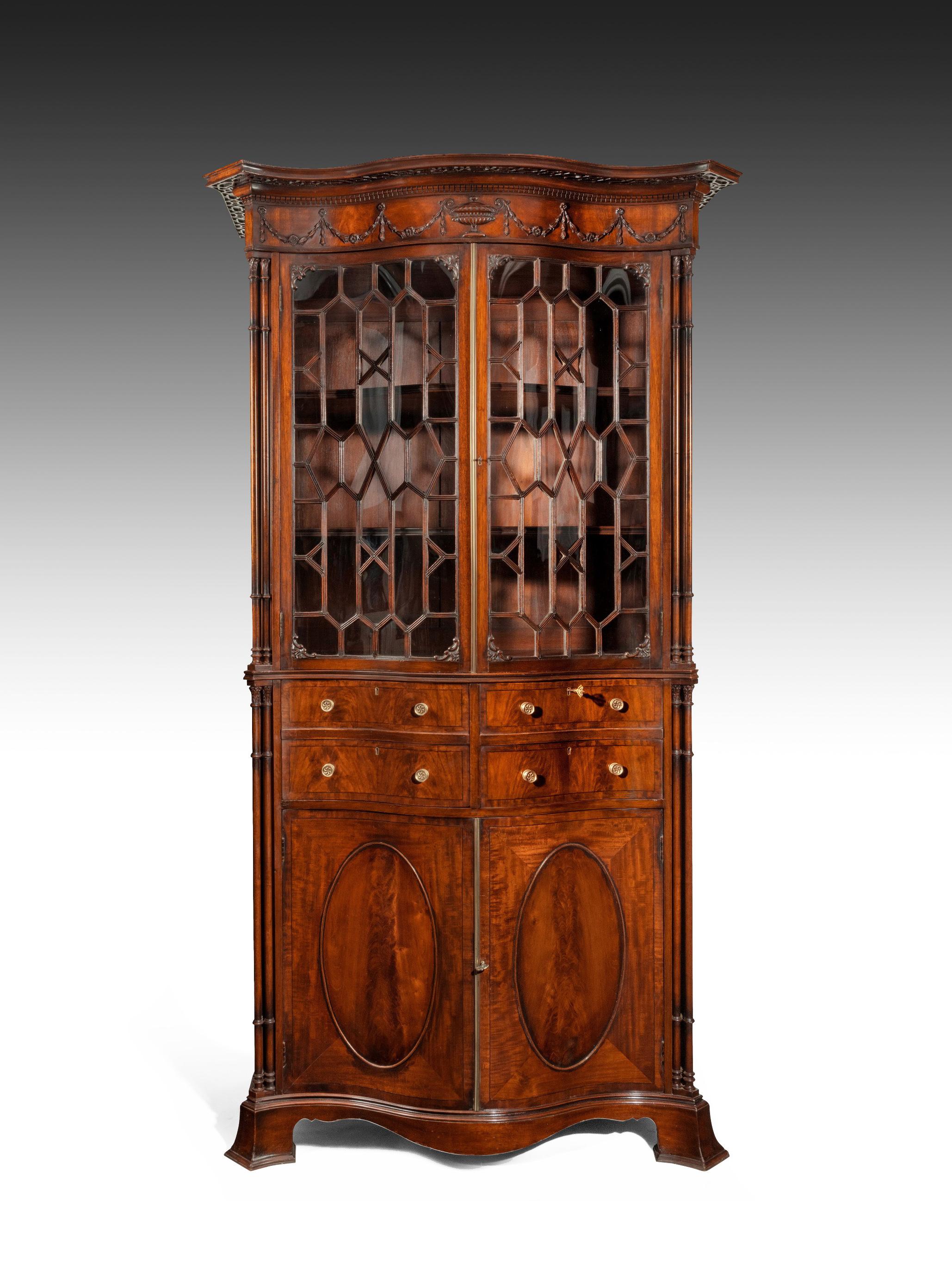 A decorative mahogany secretaire bookcase of impressive proportions in the manner of Thomas Chippendale.

English, circa 1900.

Of impressive stature, this well made George III style bookcase of serpentine form has all the classics designs of