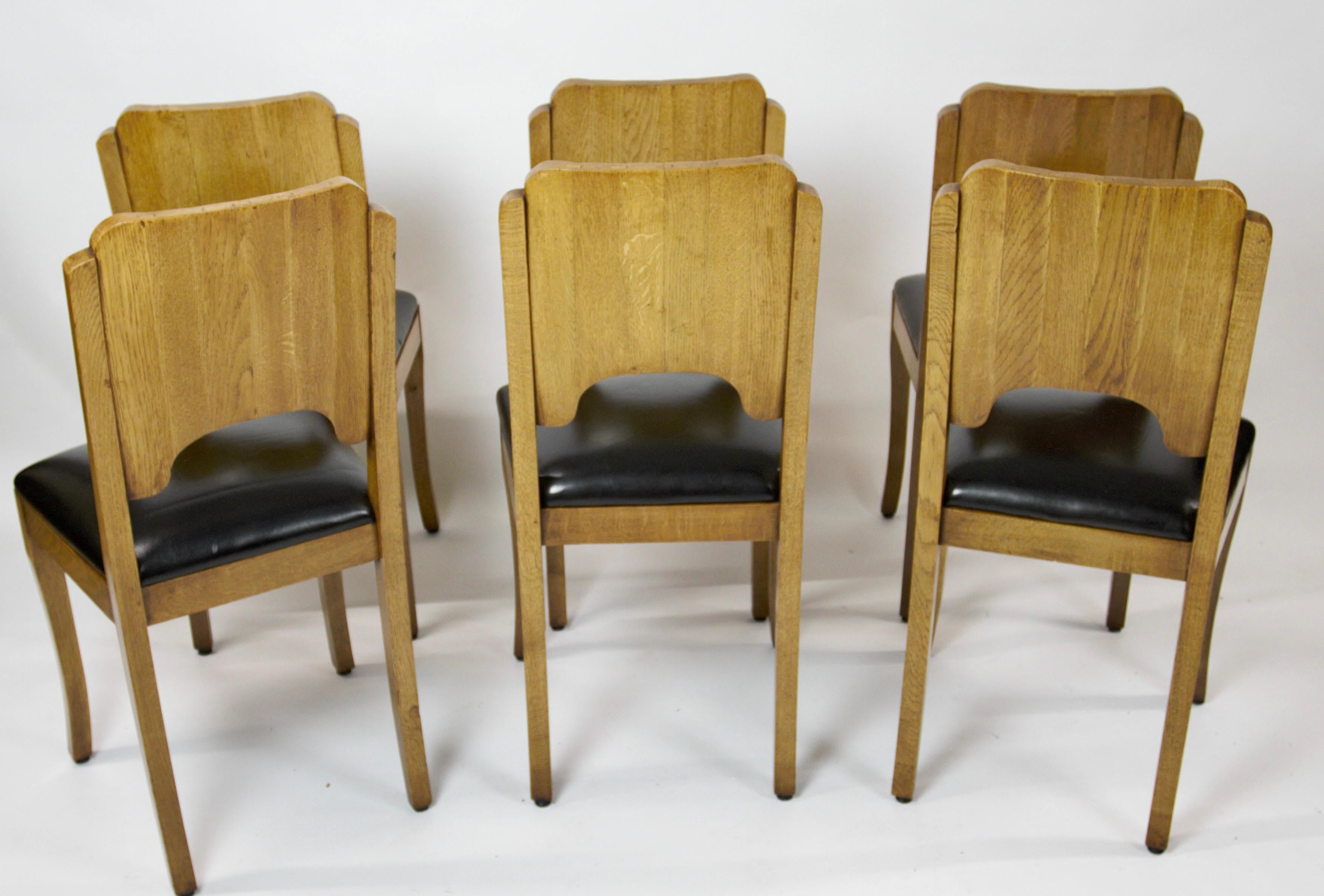 Fine Set 6 Art Deco Oak Dining Chairs circa 1930s
Curved Backs, with vertical panels, each bowfronted fixed by wedges on top & beneath
Arch Shape Under,
Black Leather seats, 
pair curved & splayed front legs, 
Recently Stripped Back & Bleached Then