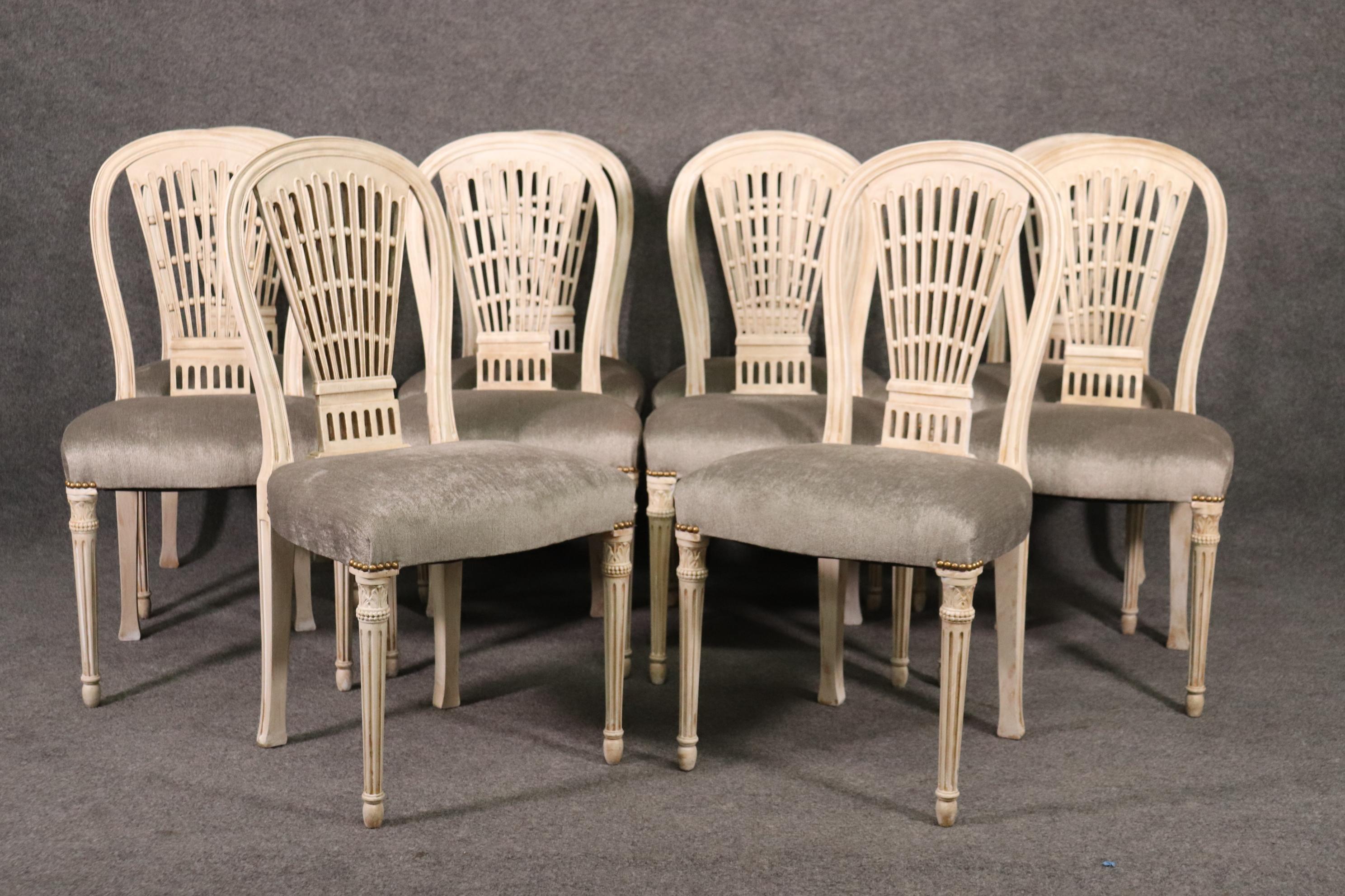 This is a newly upholstered set of 8 Maison Jansen chairs. Each chair is beautifully carved and painted in an antique distressed painted finish. The chairs are in excellent condition and have new upholstery so no stains. They each measure 37 tall x