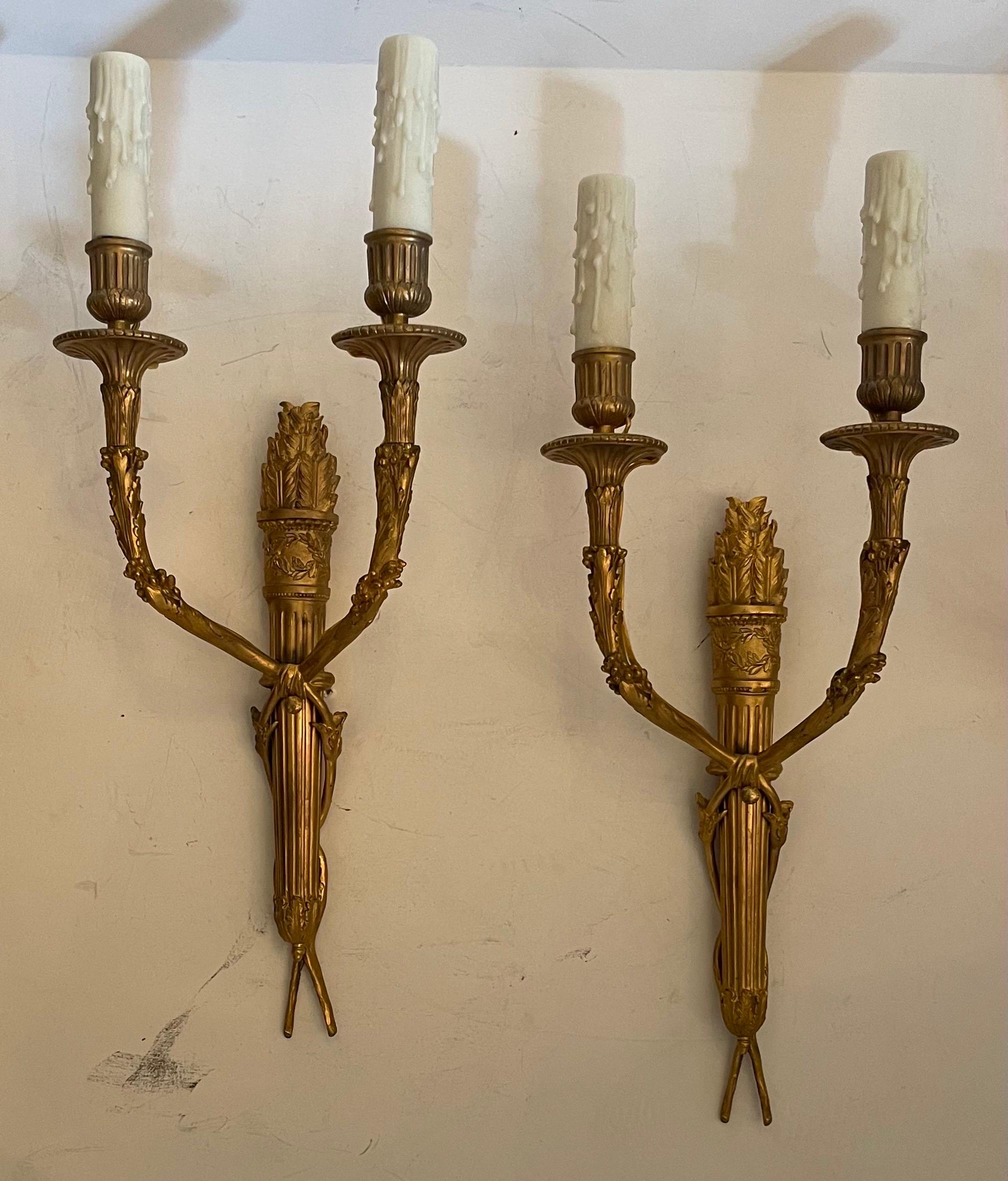 A wonderful set of four French dore bronze regency, neoclassical, Empire style torchiere two candelabra light sconces 
In The Manner Of François Linke.