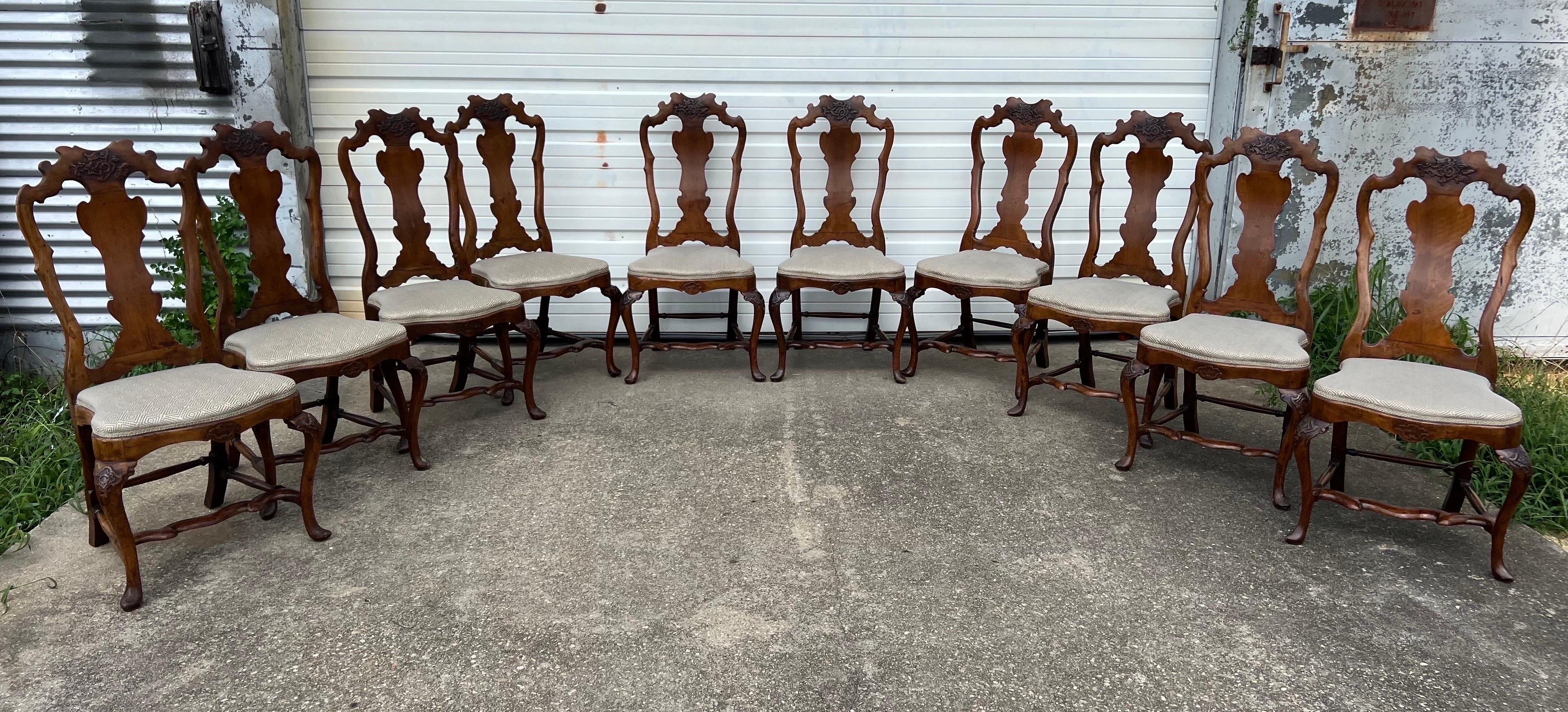 Very fine set of 10 18th century Italian carved walnut dining chairs from the late baroque- early rococo period. Recently upholstered in an attractive fortuny fabric with no stains observed. Early sets of chairs of this size are quite rare to find.