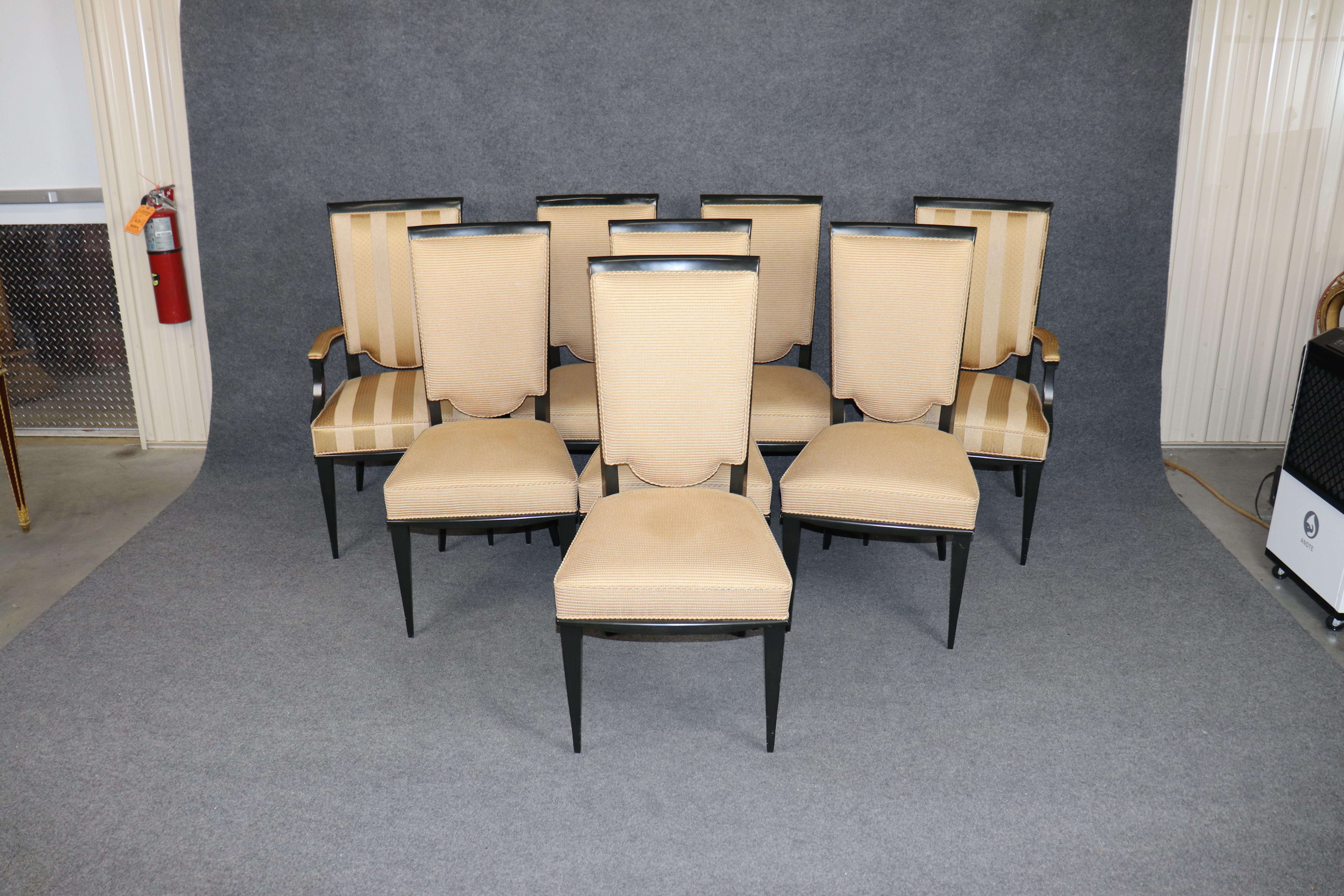 Dieses außergewöhnliche Set aus acht französischen Esszimmerstühlen im Art-déco-Stil strahlt zeitlose Raffinesse und raffinierte Handwerkskunst aus. Die Stühle verfügen über schlichte Gestelle aus ebonisiertem Holz mit klaren, geometrischen Linien,