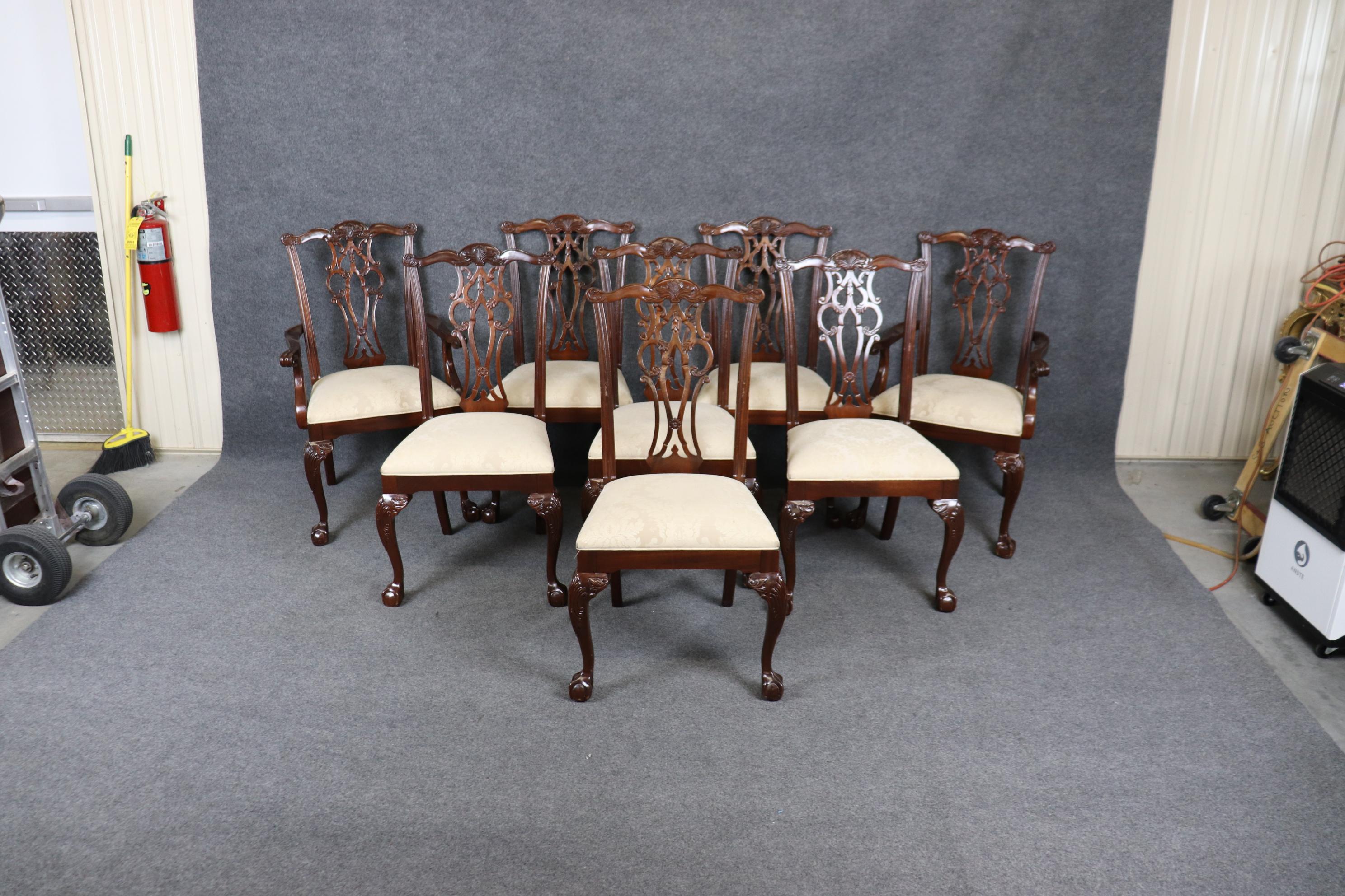 This is a gorgeous set of 8 solid mahogany Maitland Smith attributed Chippendale dining chairs in good original vintage condition. The chairs feature gorgeous carved backspalts in a fine design and gorgeous damask upholstery. The chairs will show