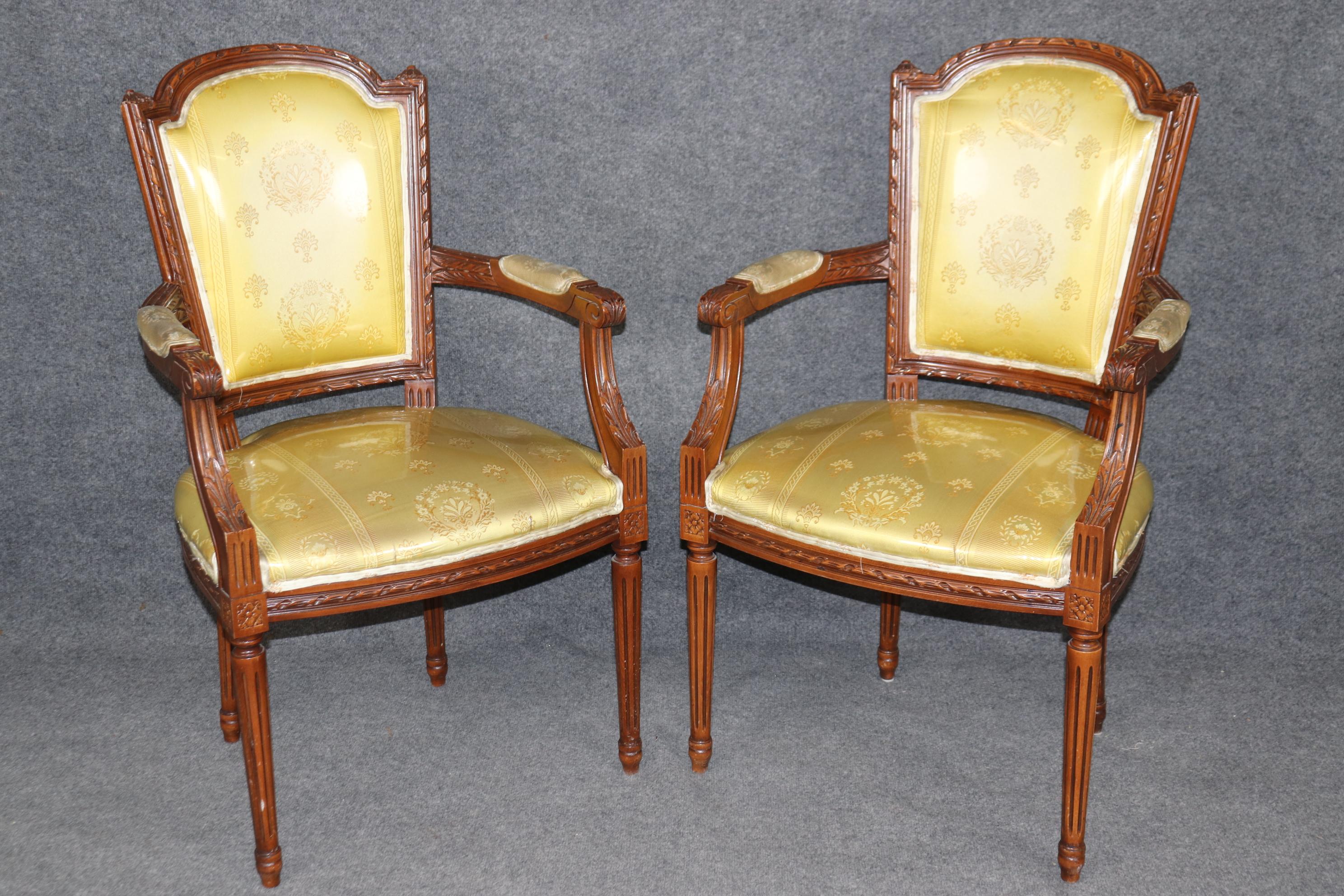 This is a gorgeous set of carved 1920s era walnut dining chairs. The chairs are in good condition and has plastic slip covers protecting their older or perhaps original upholstery. The plastic can of course be removed. The chairs are strong and