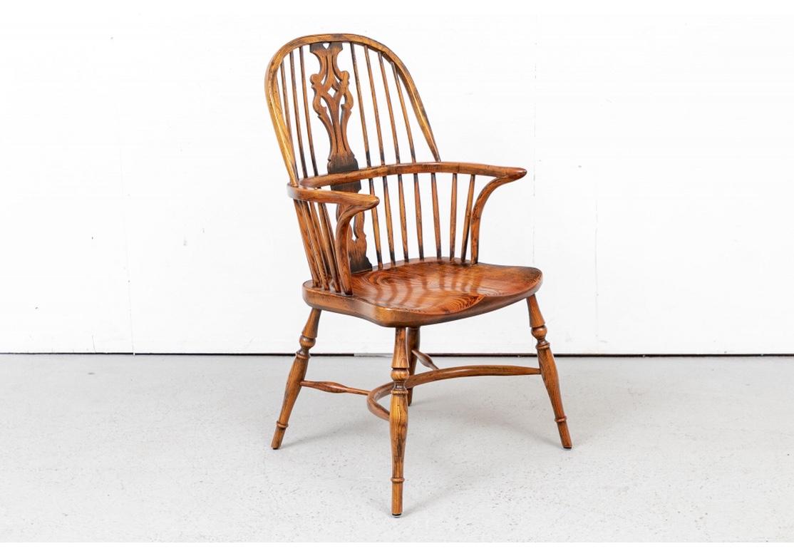 A particularly great set of 8 hardwood Windsor chairs with traditional English form, great graining and craftsmanship. A very Fine set of finished hardwood Windsor Chairs in a desirable Carmel finish having Pierced Vasiform-form splats dividing two