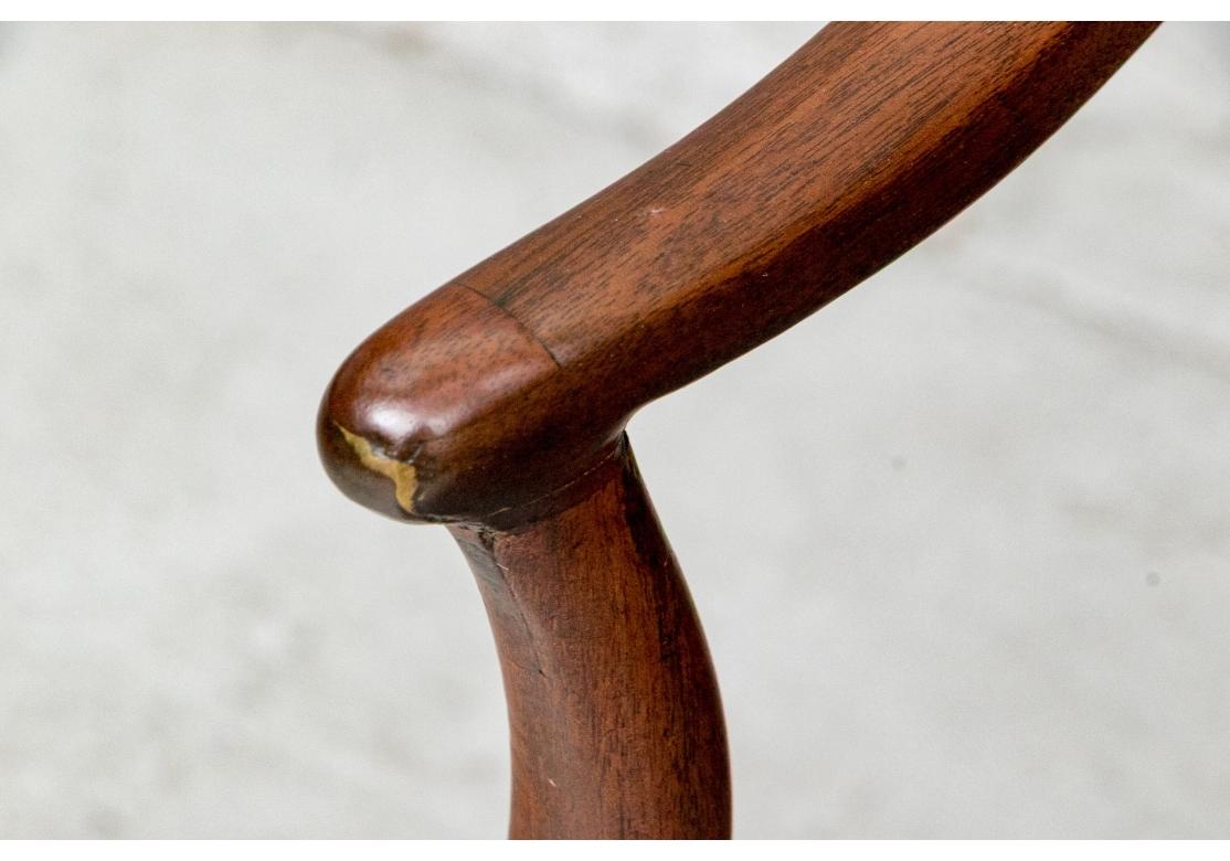 An attractive set of dining chairs Including two arm and six side chairs. Finely made mahogany dining chairs with arched pierced splats with carved bell flower detail above and open quatrefoils below. Raised on square legs, splayed in back and with