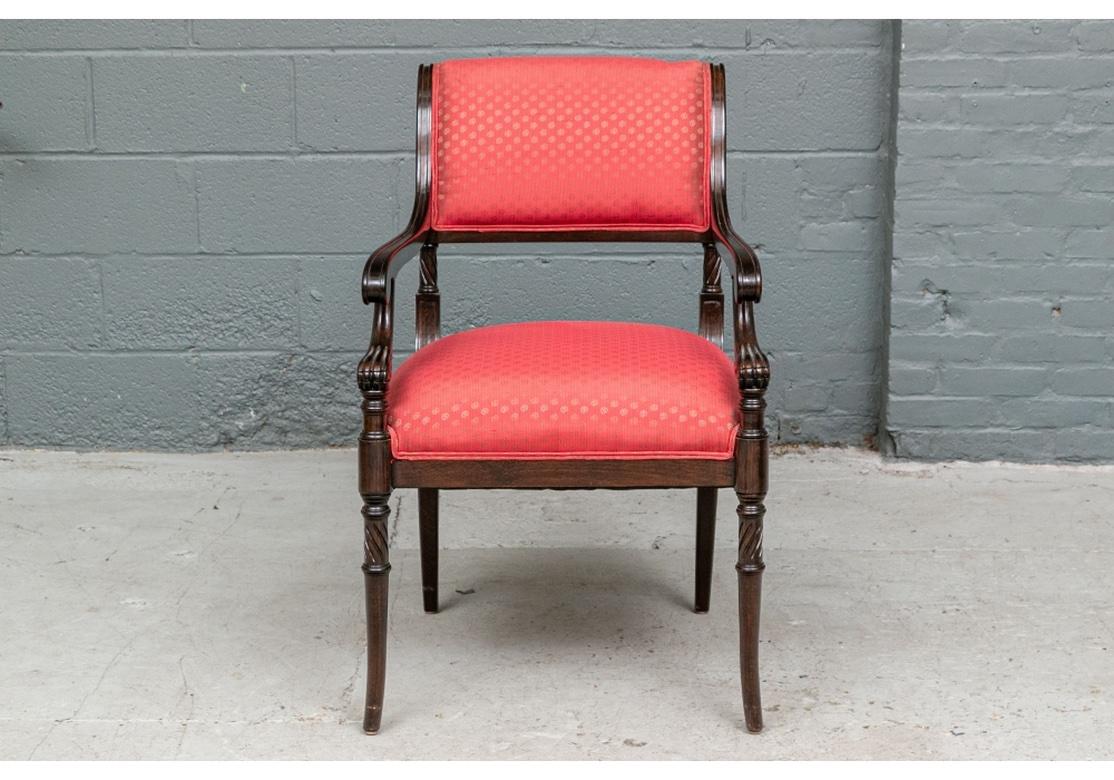 A particularly elegant set of Chairs with a very interesting and somewhat complex Neoclassical styling. With four arm and four side chairs. Fine wood frames in a dark stain with scrolled turned and blocked stiles leading to the upholstered seat.