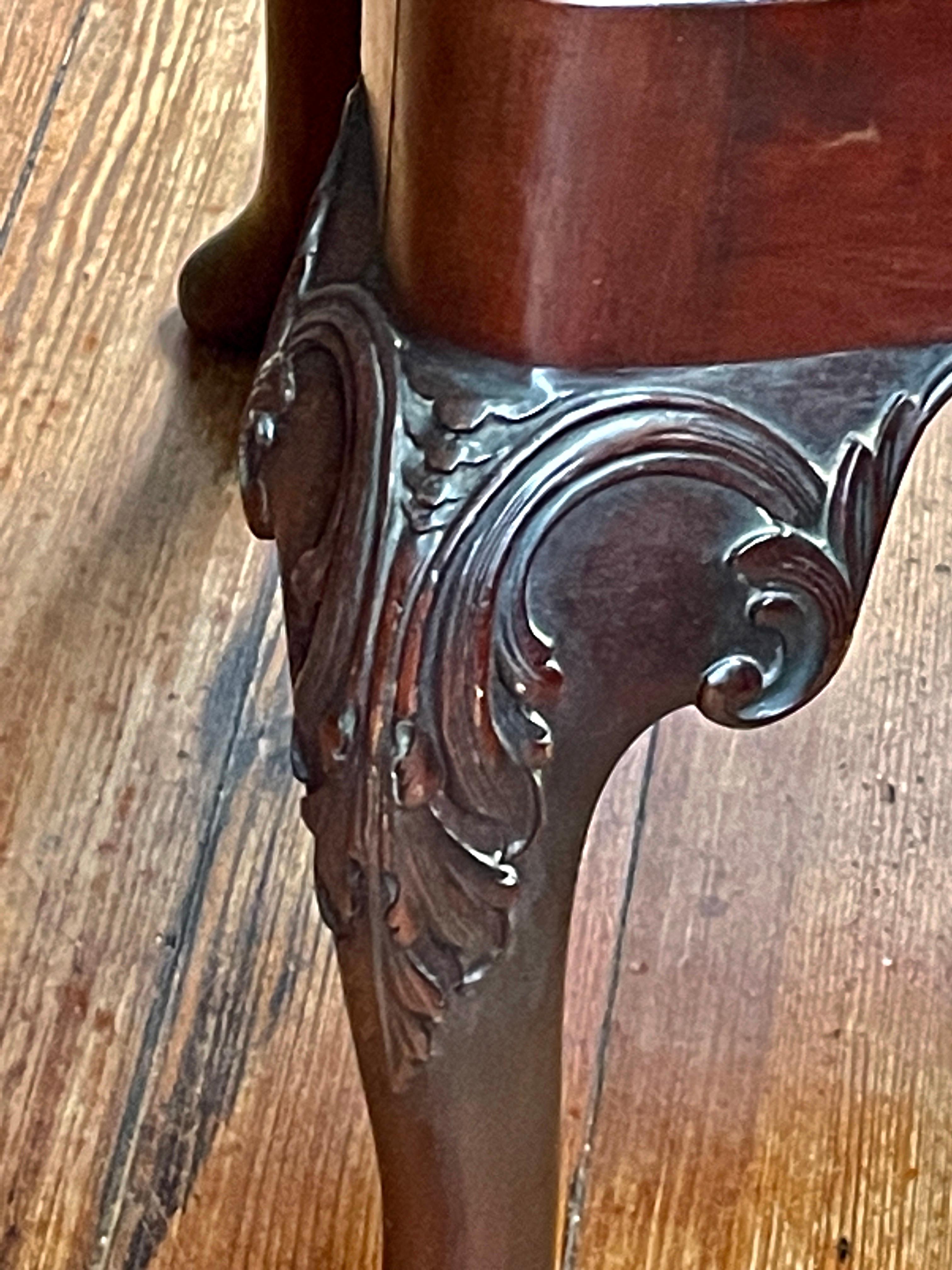 An extremely Fine Set of Eight (six sides, two arms) Antique English Geo. II style hand-carved solid mahogany Dining Chairs with carved and pierced back splat, balloon shaped slip-in upholstered seats and cabriole legs terminating in a hand-carved