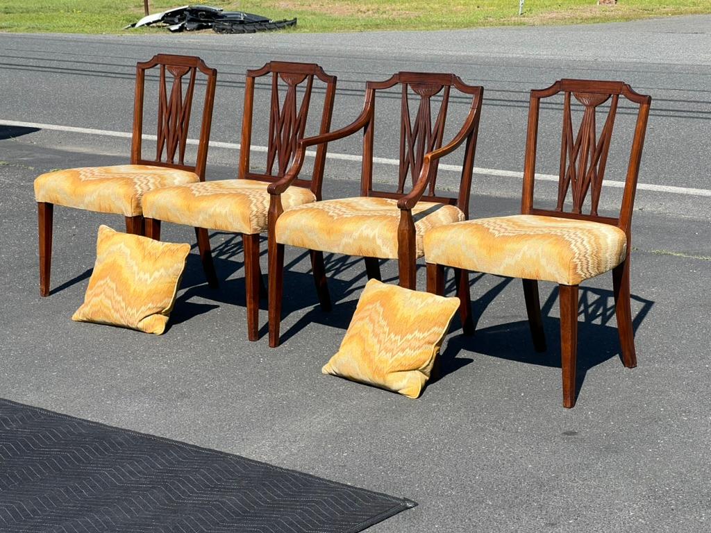 Introducing a fine set of four Antique 18th Century Carved Mahogany Hepplewhite Chairs, each piece exemplifying the exquisite craftsmanship and timeless elegance characteristic of the Hepplewhite style. Dating back to the 18th century, these chairs