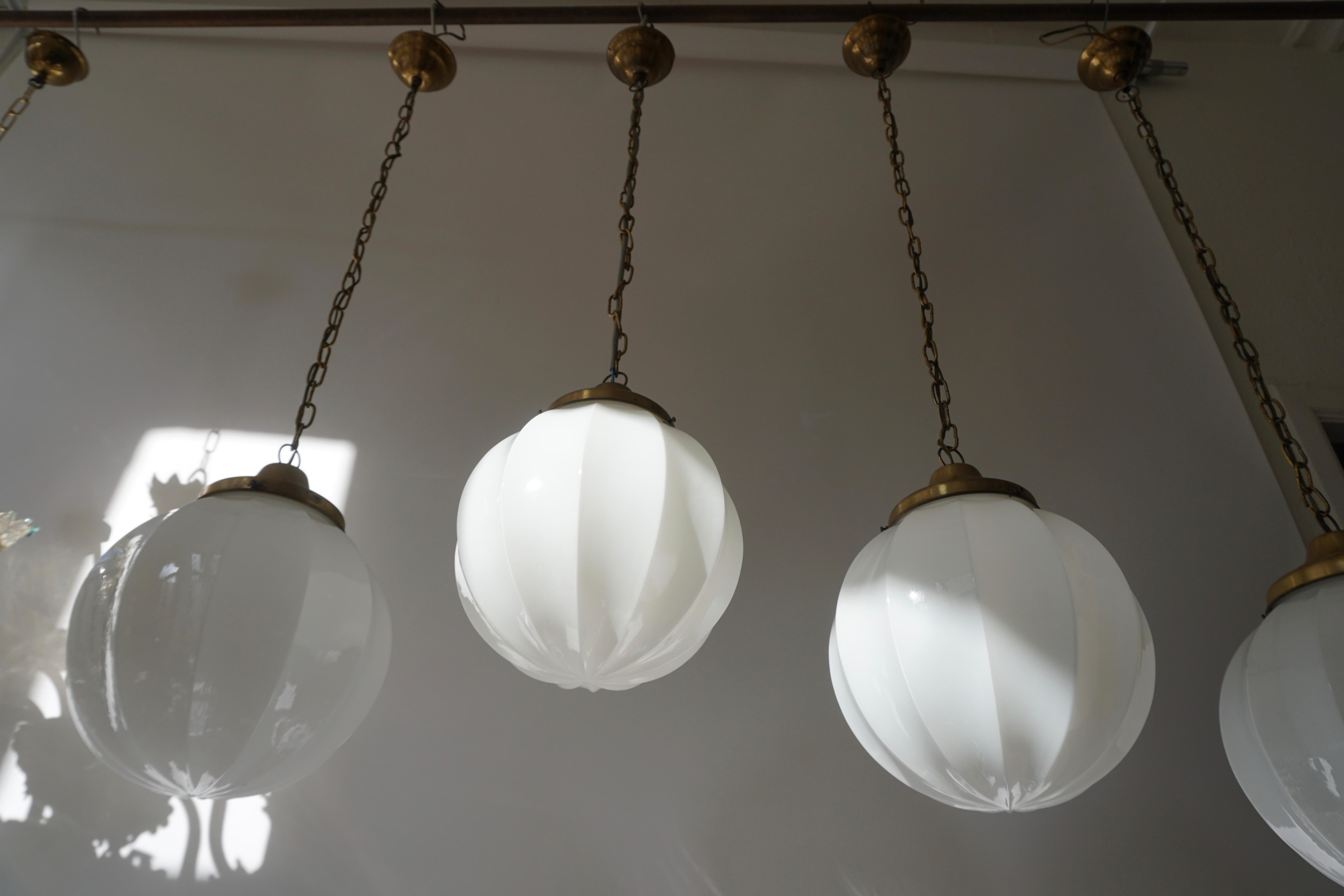 Brass Fine Set of Four Art Deco Opaline Glass Pendants