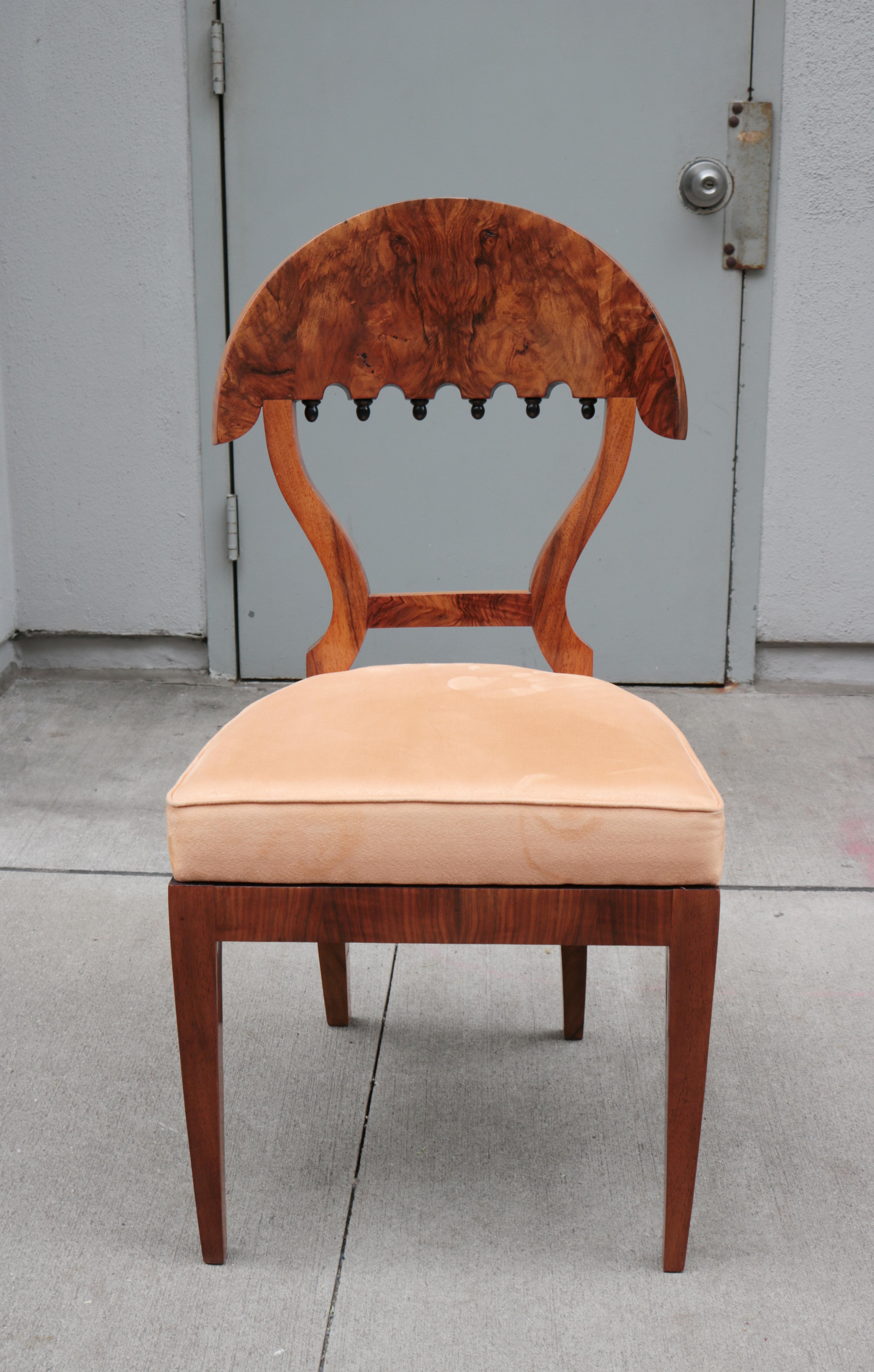 A fine set of four Biedermeier side chairs.
Walnut burl with ebonized details.