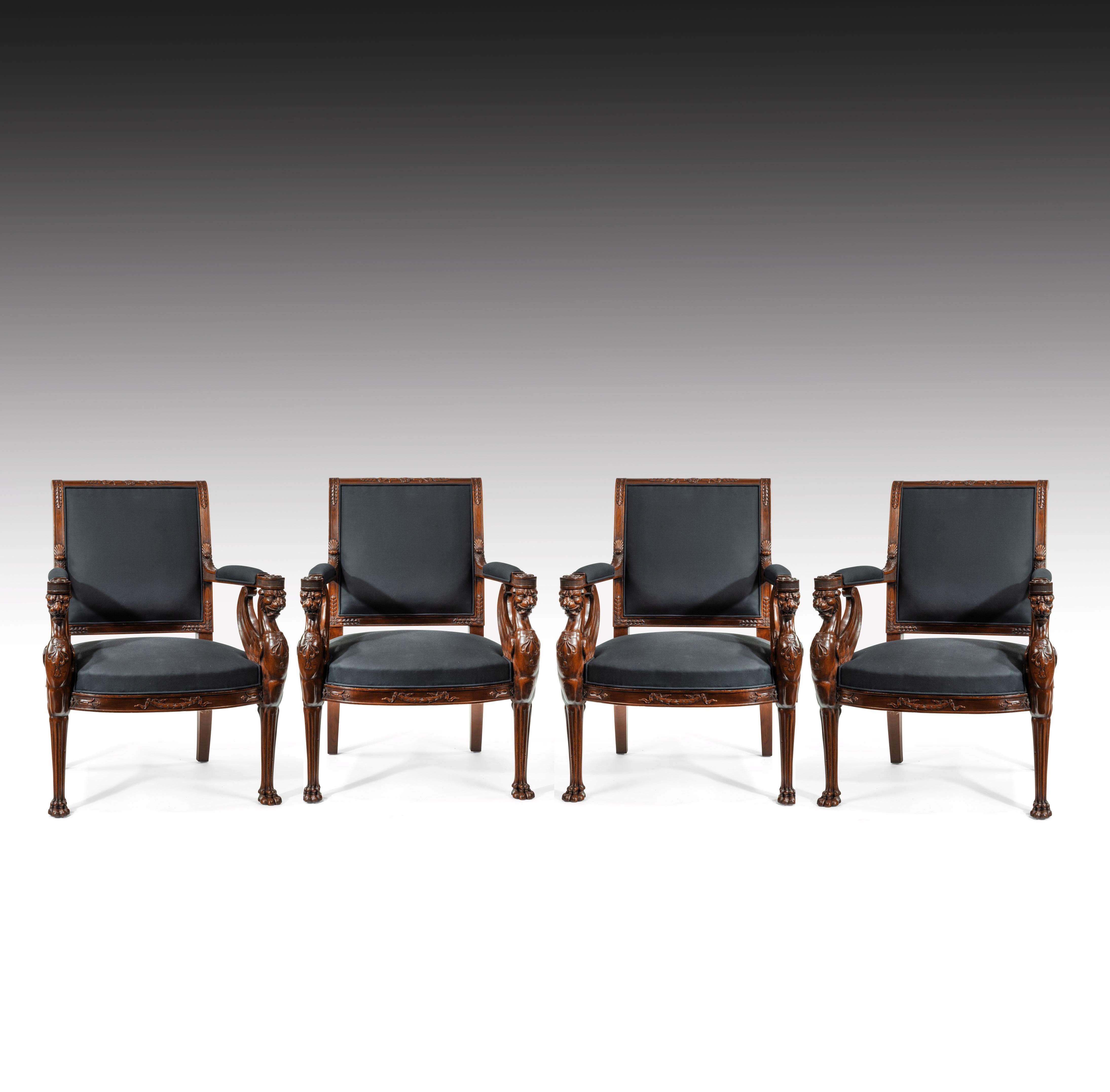 An extremely fine and well executed set of four, carved mahogany Empire period open fauteuils, upholstered in a black calico, by repute from a Royal collection.

European, circa 1810.

The gently raked, out-scrolled rectangular backs, with