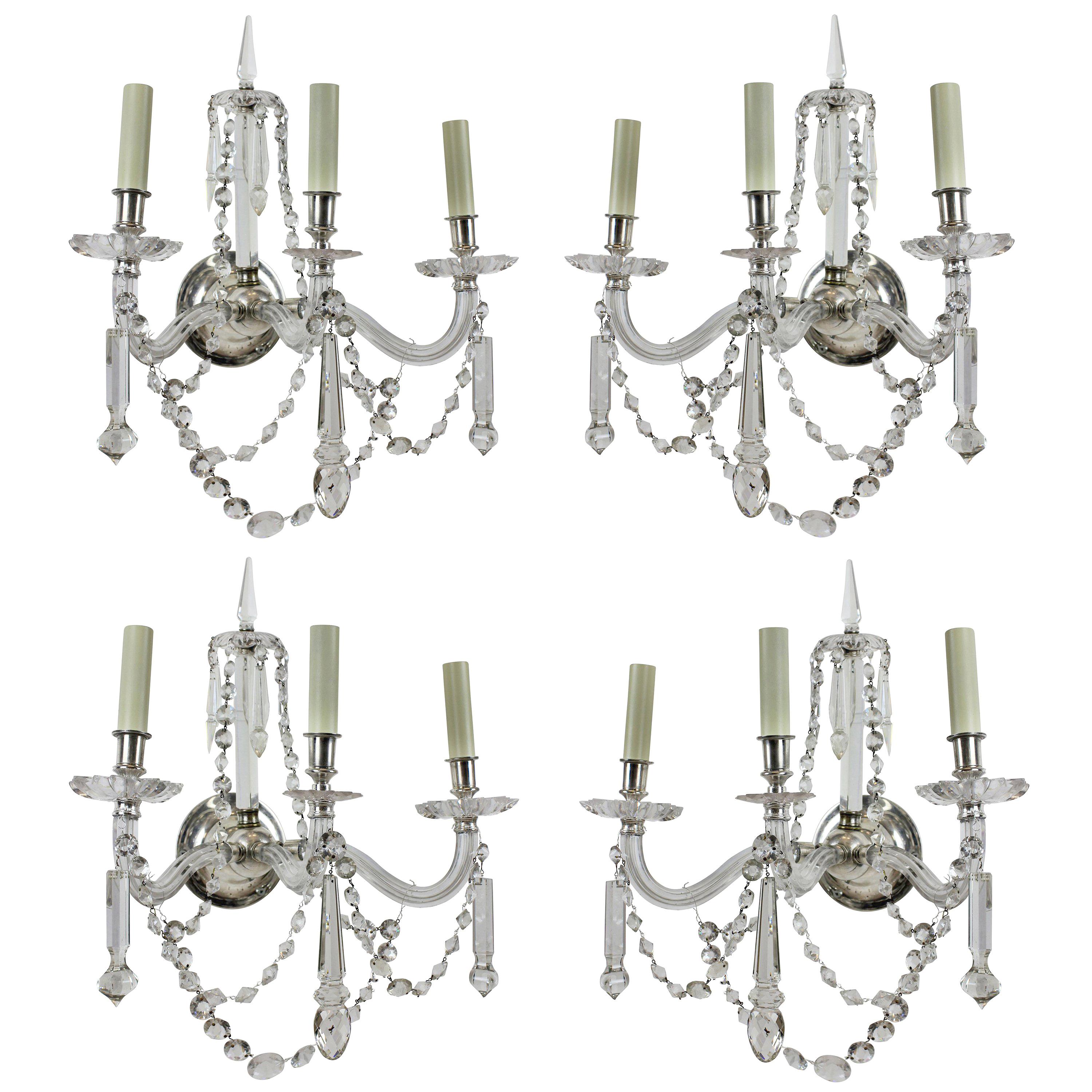 A fine set of four English cut-glass, three branch wall sconces. Beautifully hung with swags and spires.
                  