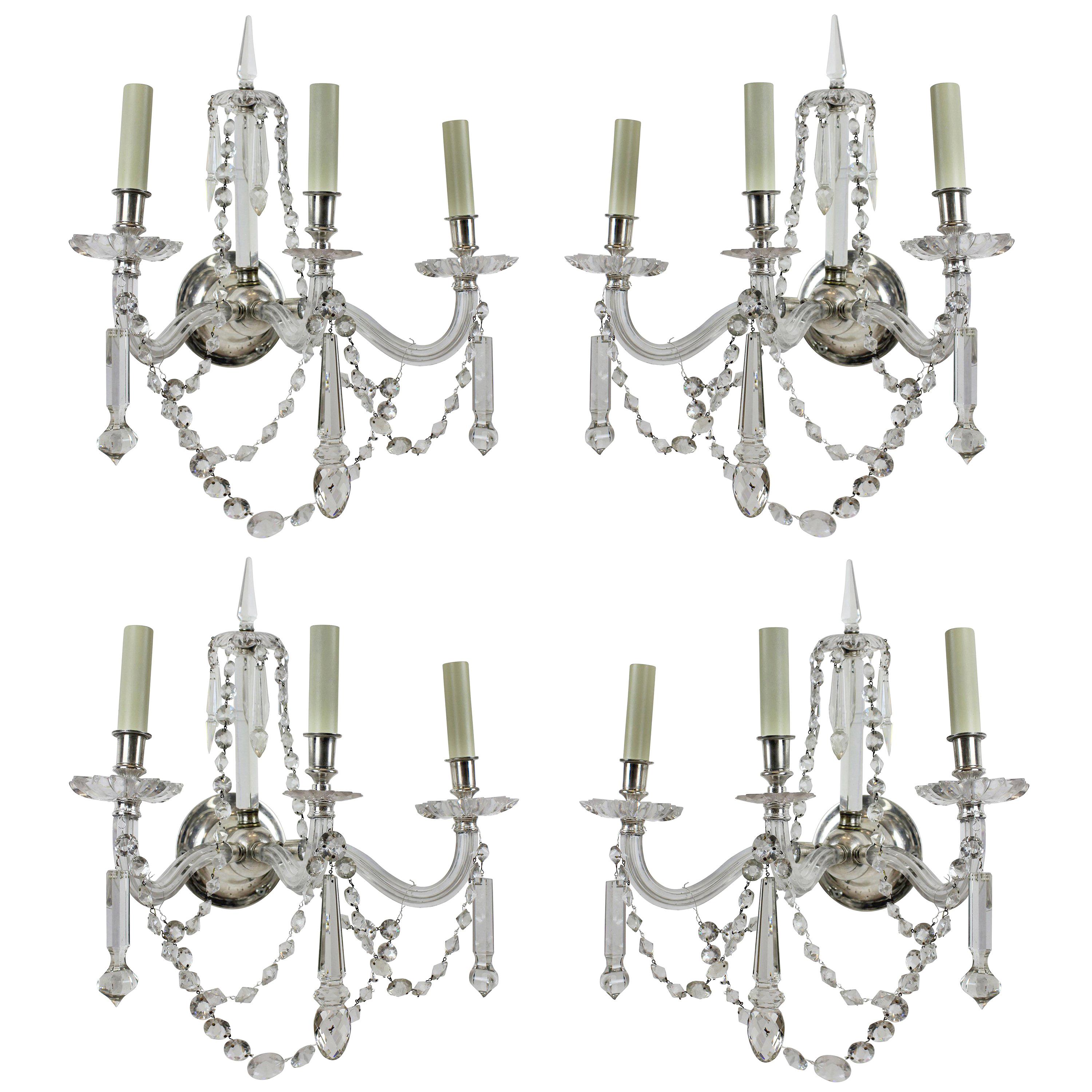A fine set of four English cut-glass, three branch wall sconces. Beautifully hung with swags and spires.
            