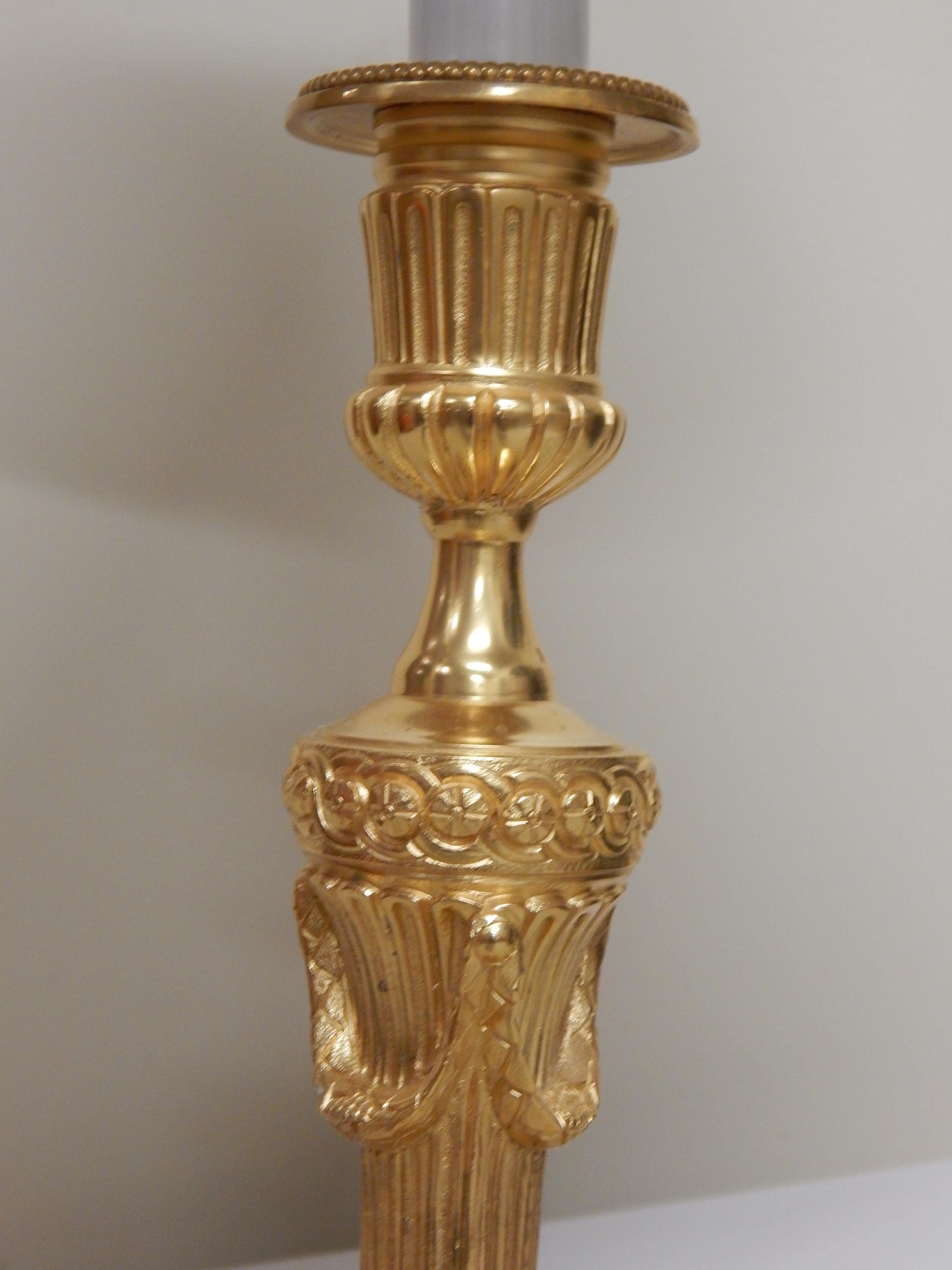An excellent quality set of four Louis XVI style doré bronze candlestick lamps.