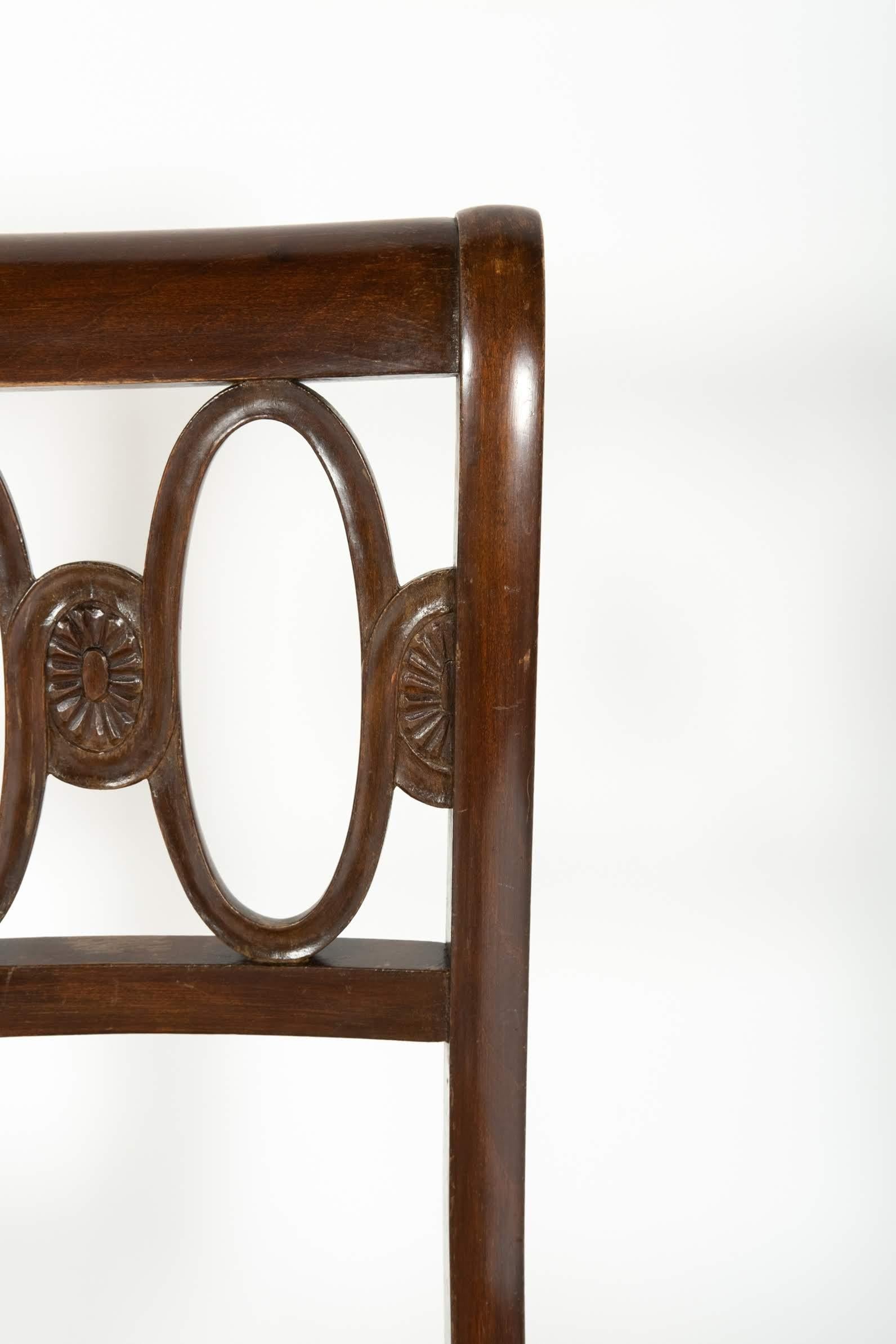 Set of four elegant mahogany chairs, finely decorated and upholstered.