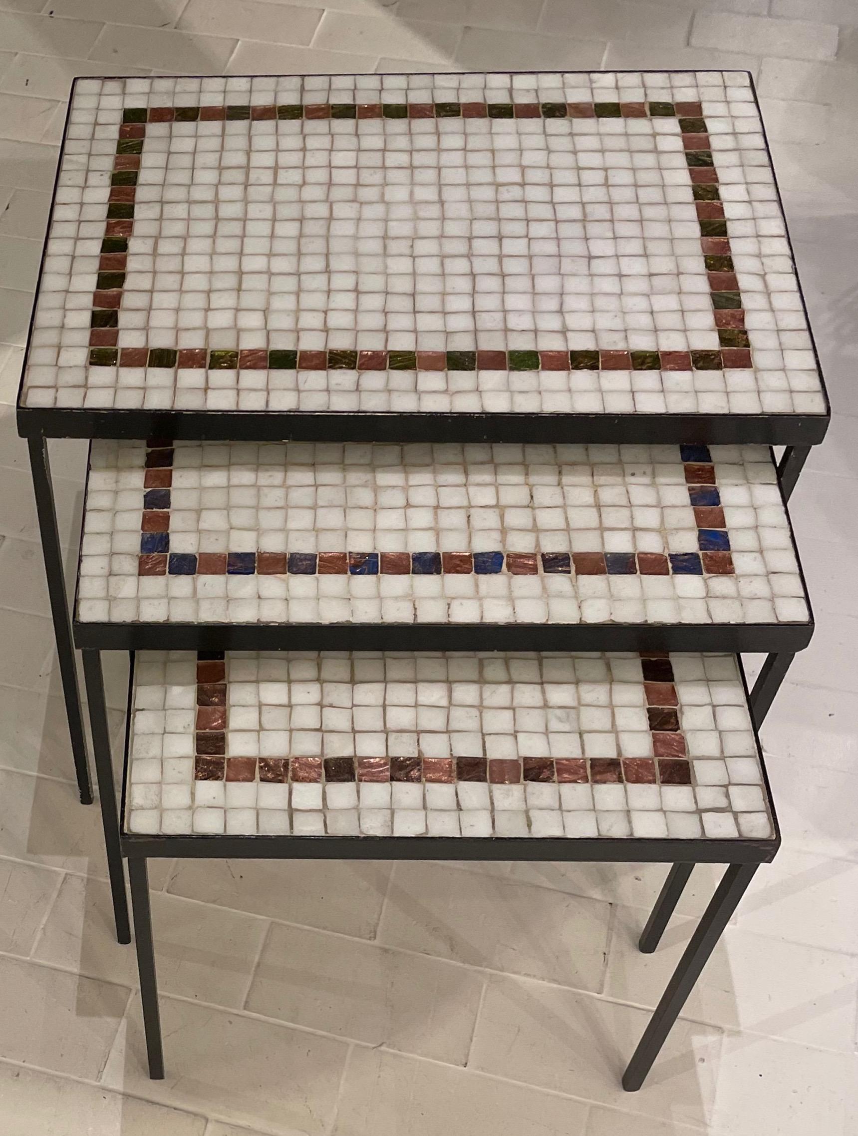 Fine set of three mosaic nesting tables.
French fifties.