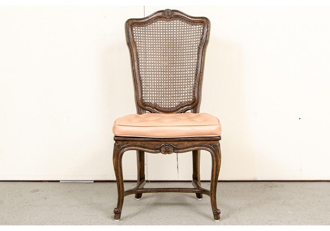 Solidly built and very well made, with good weight and stability having hand-caned seats. Fine set of six French Country dining chairs in a deep and lovely walnut color. Very comfortable and generous in size, the chairs have custom Pale Salmon