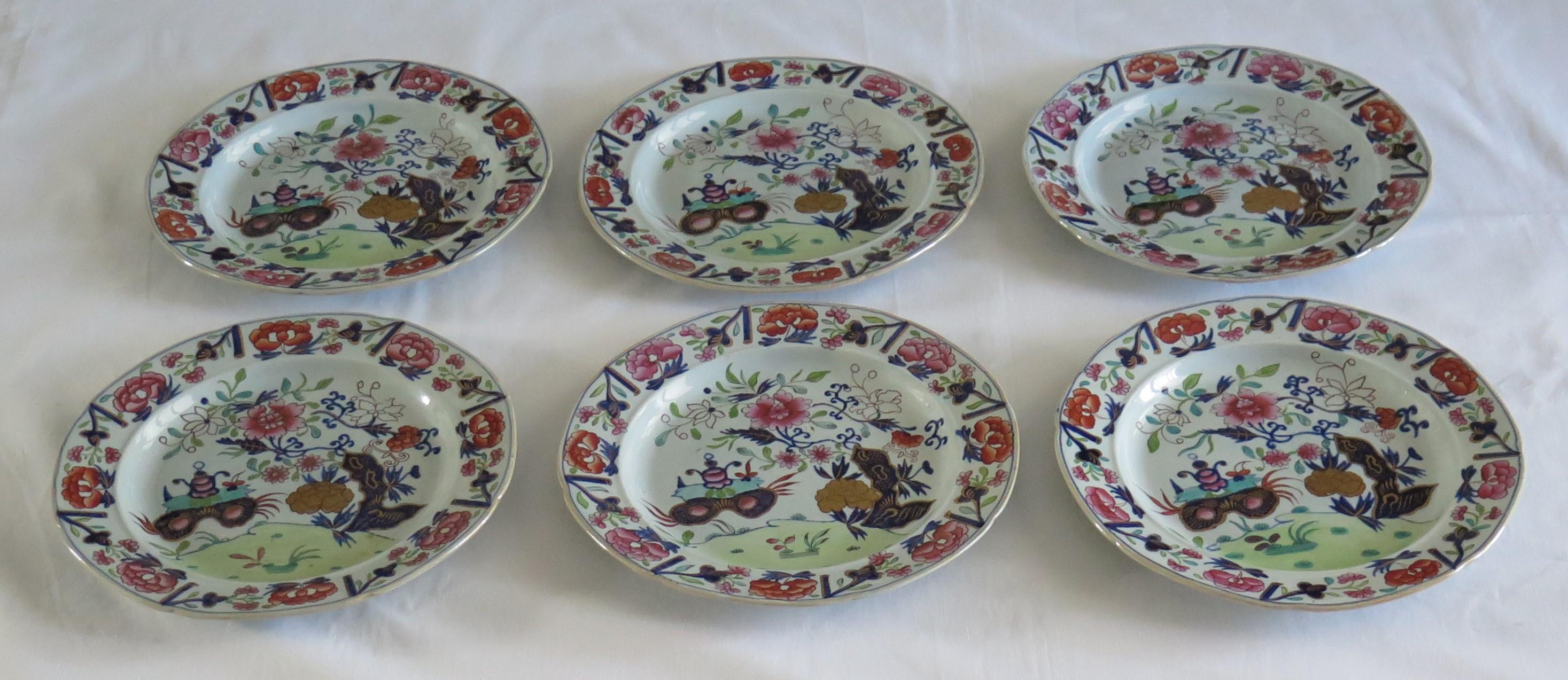 These are a fine early set of six ironstone pottery dinner plates made by the Mason's factory at Lane Delph, Staffordshire, England and beautifully decorated in the small vase, flowers and rocks pattern, fully stamped and dating to the earliest