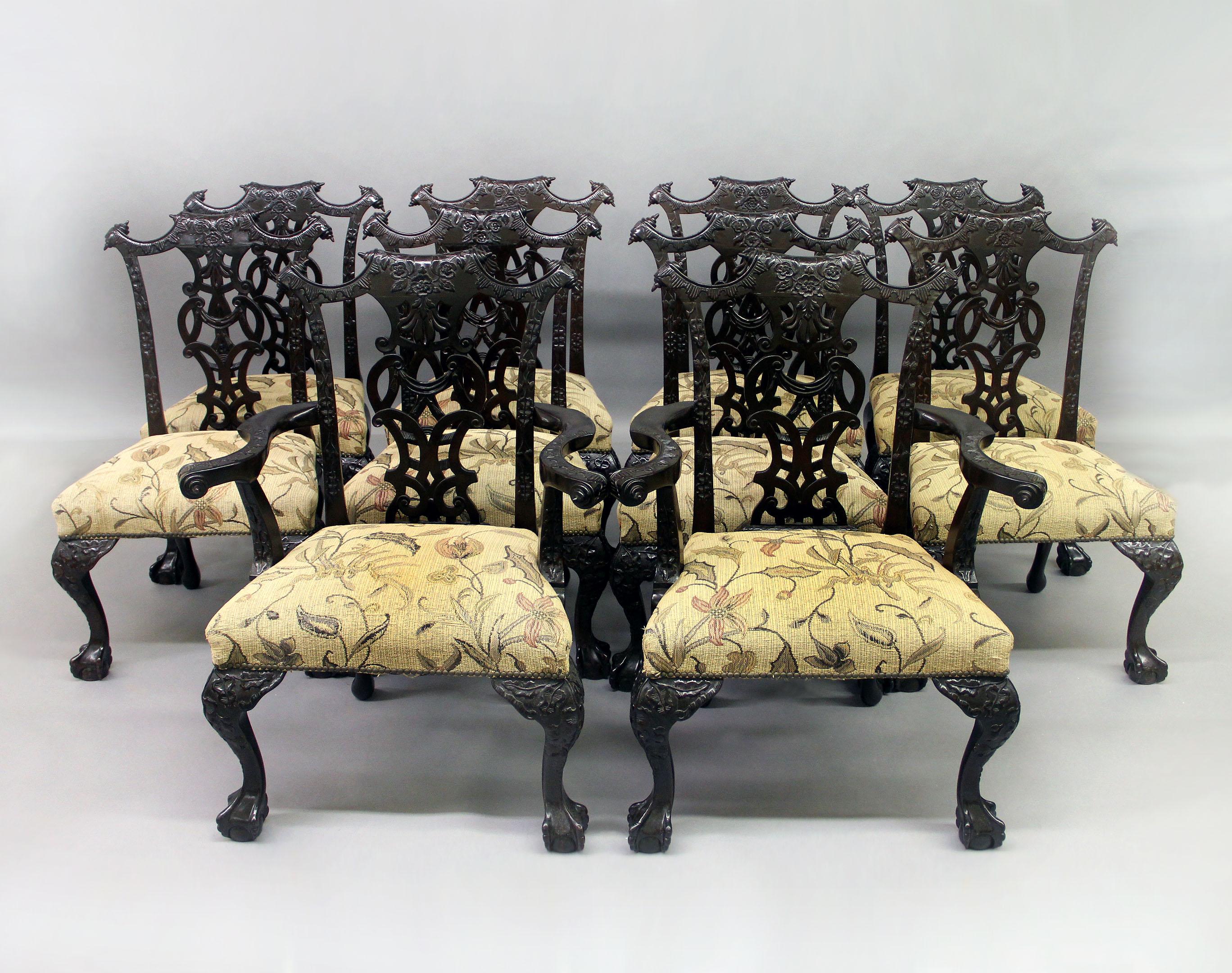 A fine set of ten late 19th century Chippendale style dining chairs

Comprising of two arm and eight side chairs.

The intertwined backs carved with roses and beautiful foliate designs, the top corners with paper scrolls. The serpentine arms