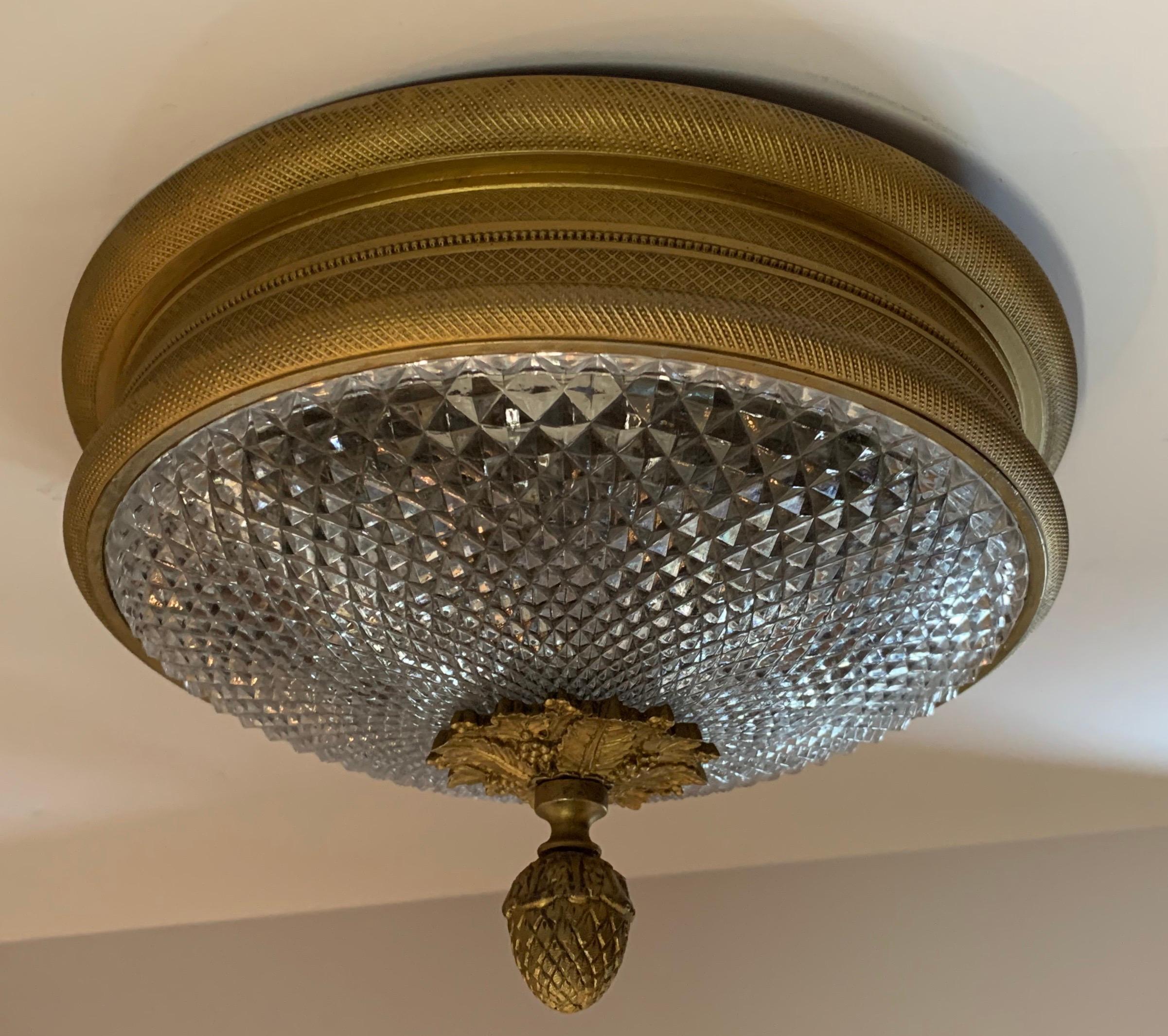 A wonderful neoclassical set of 3 Sherle Wagner vintage knurled ceiling lights in doré bronze gold patina. These low profile two-light fixtures (max 60watts per socket) are perfect for lower ceiling applications. This beautiful flush mount is finish
