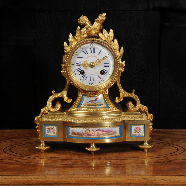A fine, early antique French clock by André Hoffmann of Paris, the movement by Vincenti et Cie, circa 1850. It is beautifully made in ormolu (fire gilded bronze doré) mounted with exquisite Sèvres style porcelain. The porcelain has a Bleu Celeste