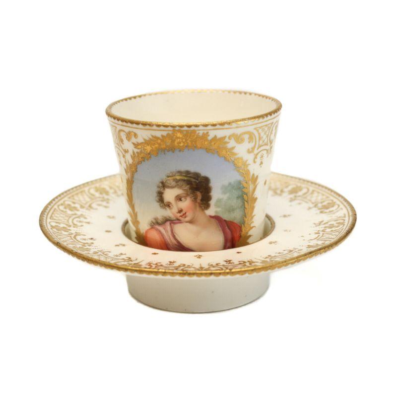 Fine Sevres Porcelain cup & saucer w/ Portrait Goblet et Sou Coupe Enfonce, 1759

An incredibly fine Sevres France hand painted porcelain cup and socketed saucer- Goblet et Sou Coupe Enfonce, 1759. Beautiful hand painted portrait of a woman in red