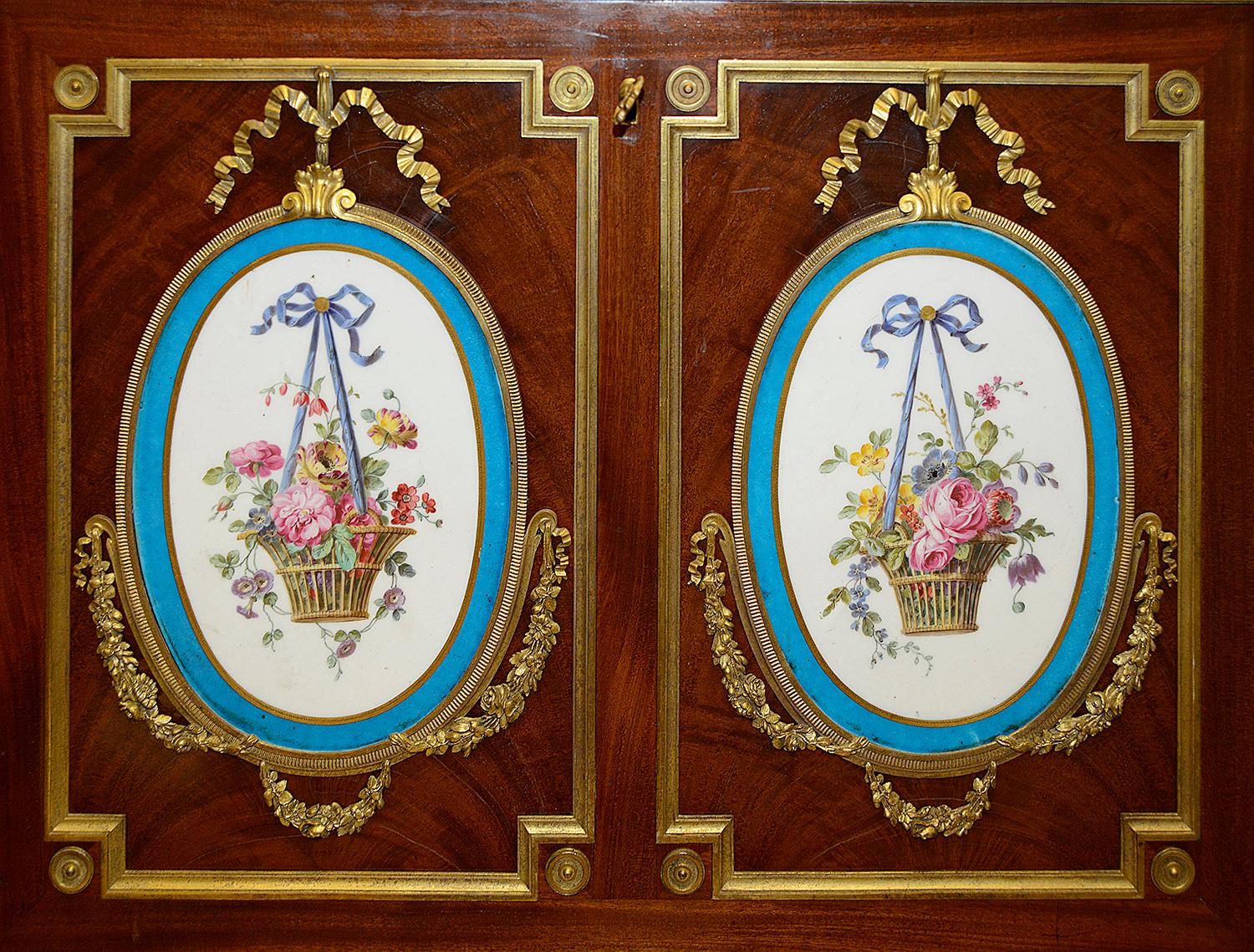 A fine quality late 19th century French side cabinet with a marble top, a fall front secrétaire, having wonderful hand painted Sevres style porcelain plaques depicting baskets of flowers with ribbons, when opened reveals compartments within and an