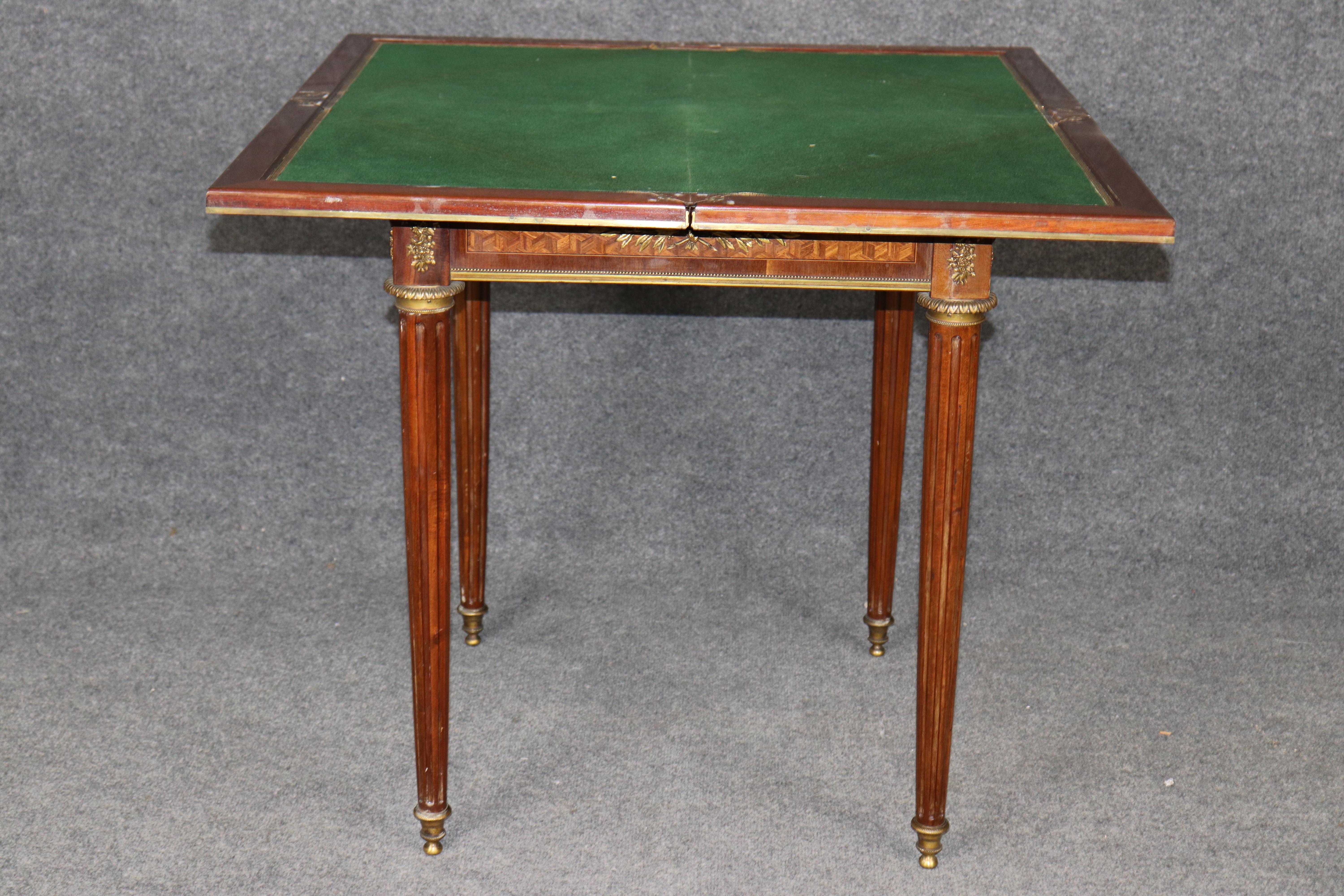 Presenting a magnificent signed Paul Sormani marquetry inlaid, bronze-mounted, doré ormolu napkin/card table, an exquisite example of 19th-century French craftsmanship at its finest. This elegant Louis XVI–style table features an extraordinary