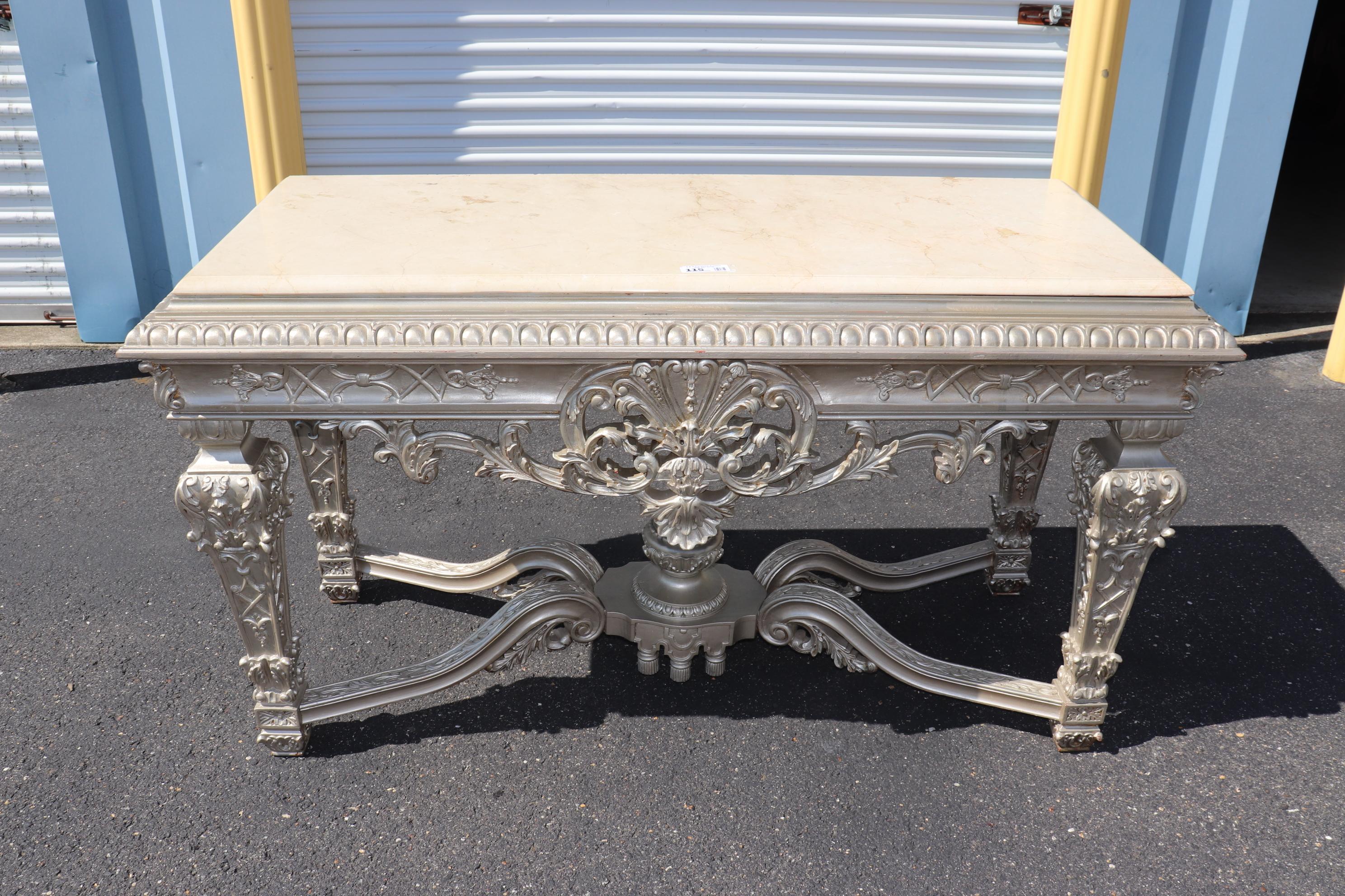 This is a gorgeous console table designed in the Georgian manner but could also be used as a Louis XIV because they have a similar design. The table is in good condition and simply has an inventory sticker on top. The table dates to the 1960s era